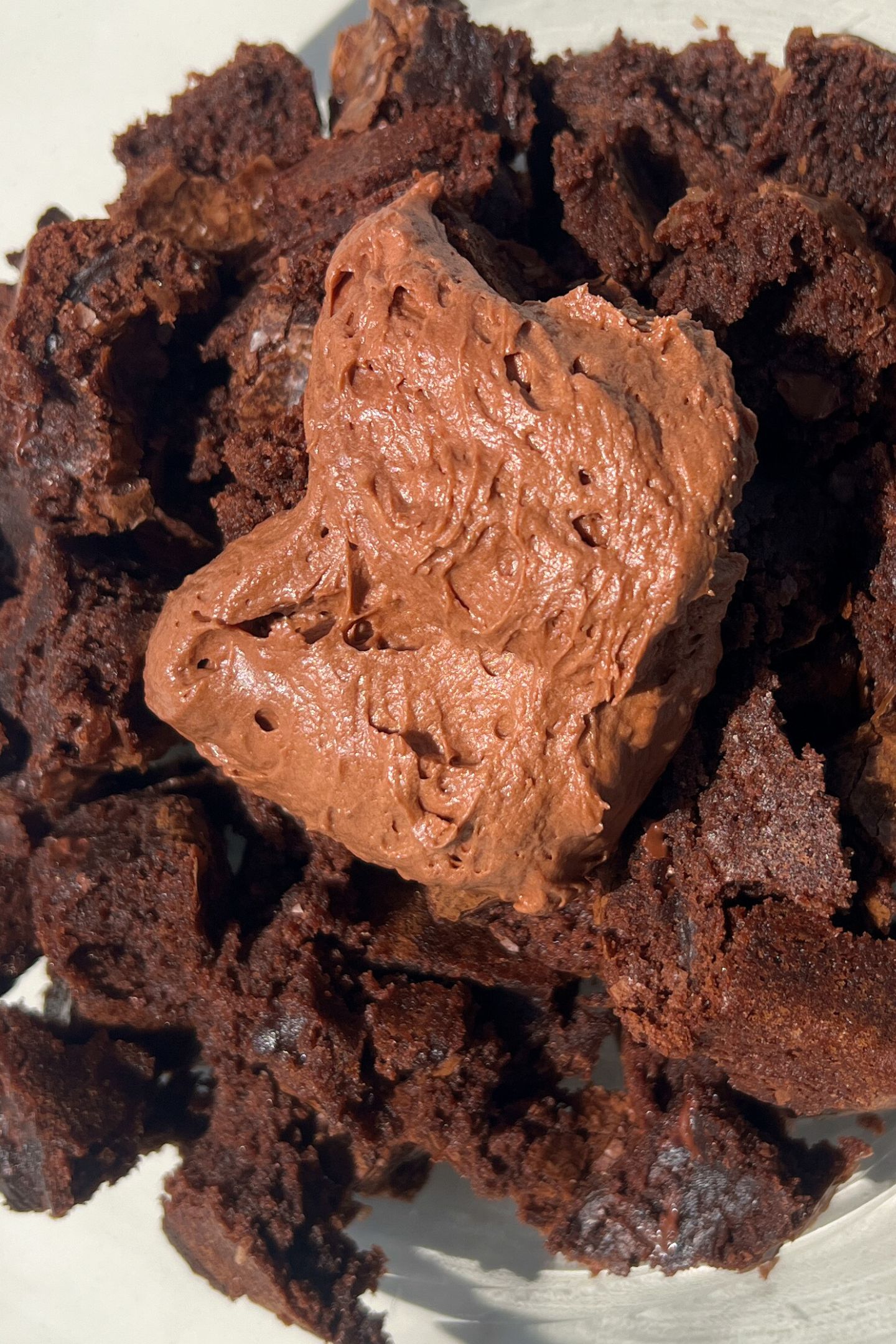 Brownie pieces in a mixing bowl with frosting