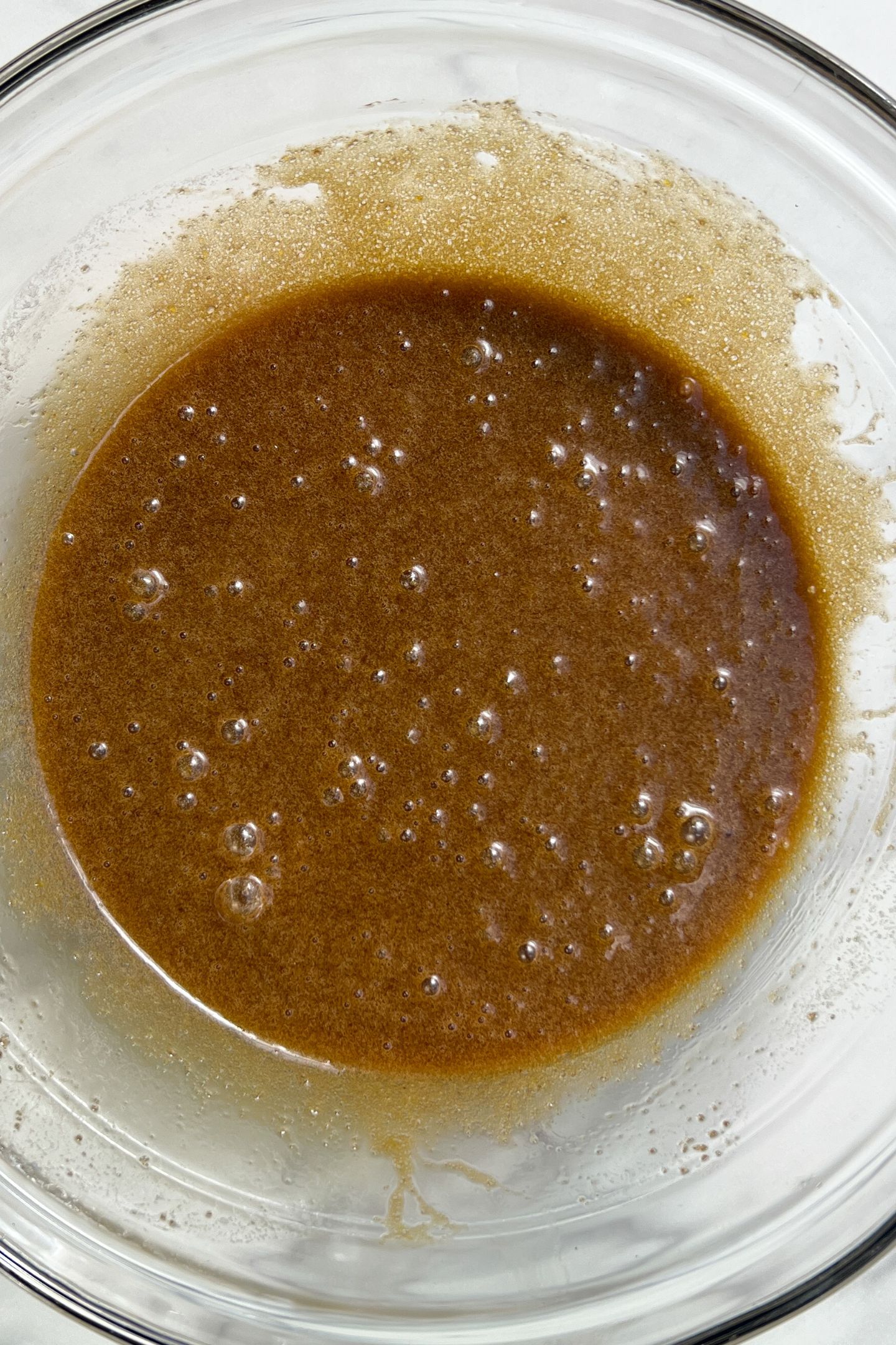 Wet ingredients whisked together in a mixing bowl.