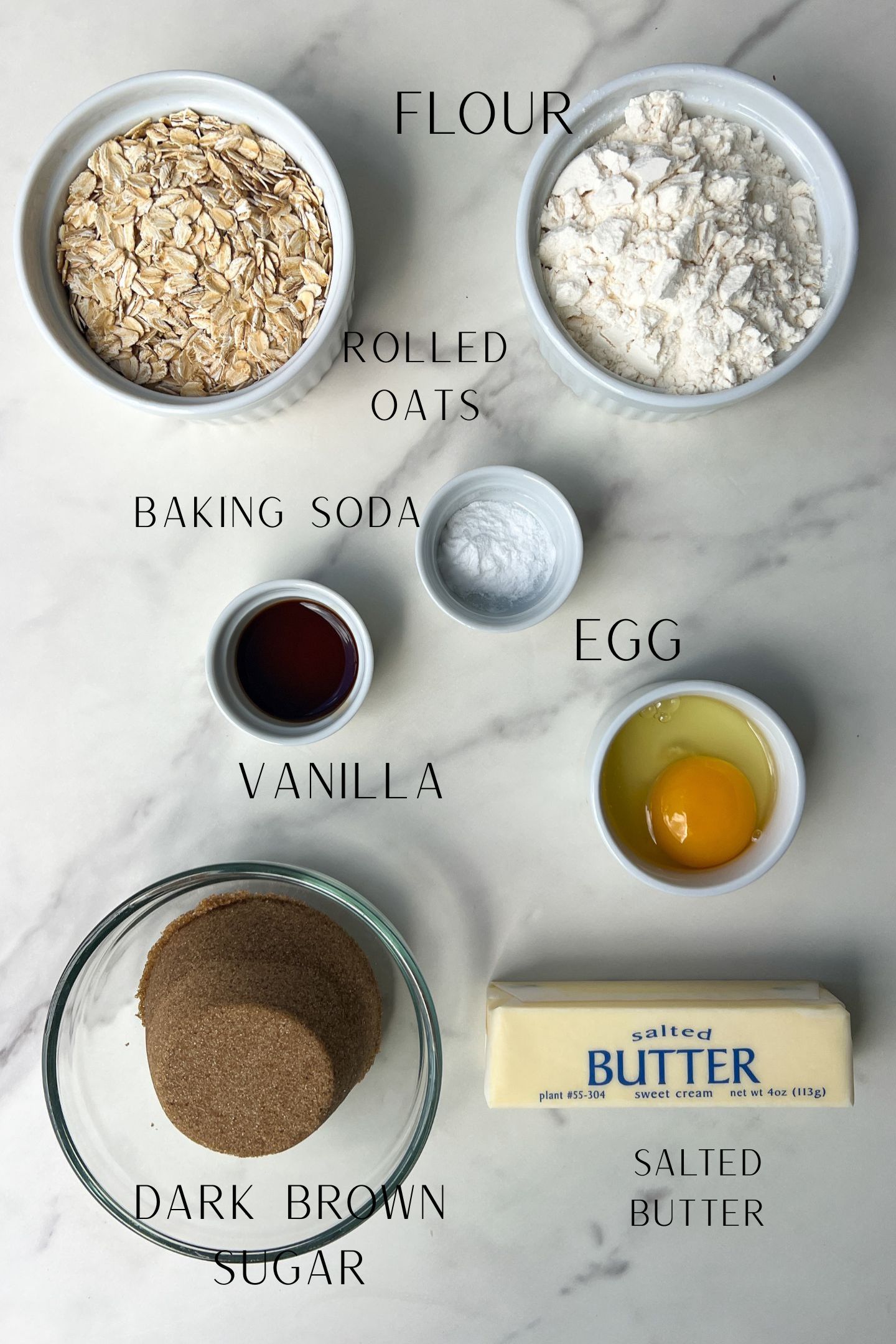 Ingredients measured out in bowls to make the soft-baked oatmeal cookie fudge bars.