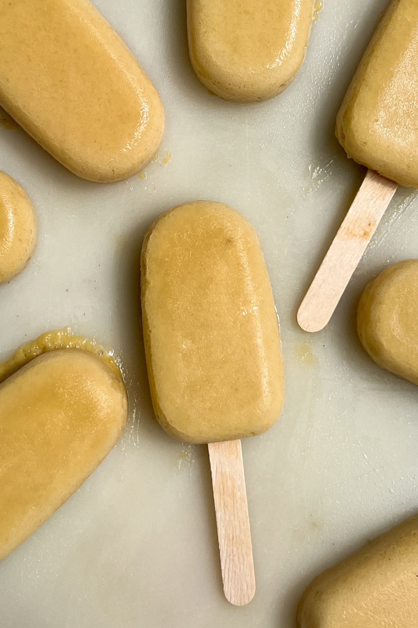 Pineapple popsicles on a tray.