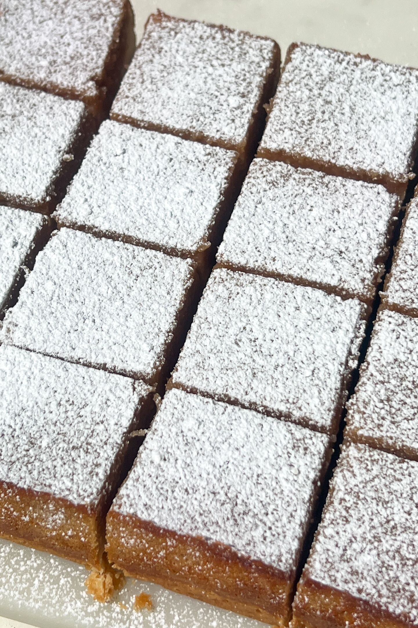 Sliced Lemon Raspberry Bars topped with powdered sugar.
