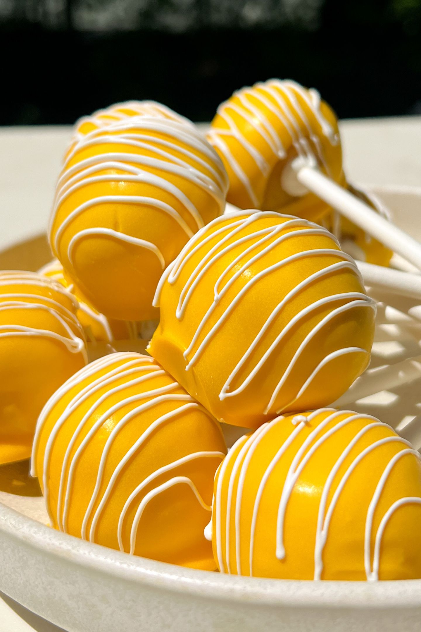 Lemon cake pops in a serving bowl.