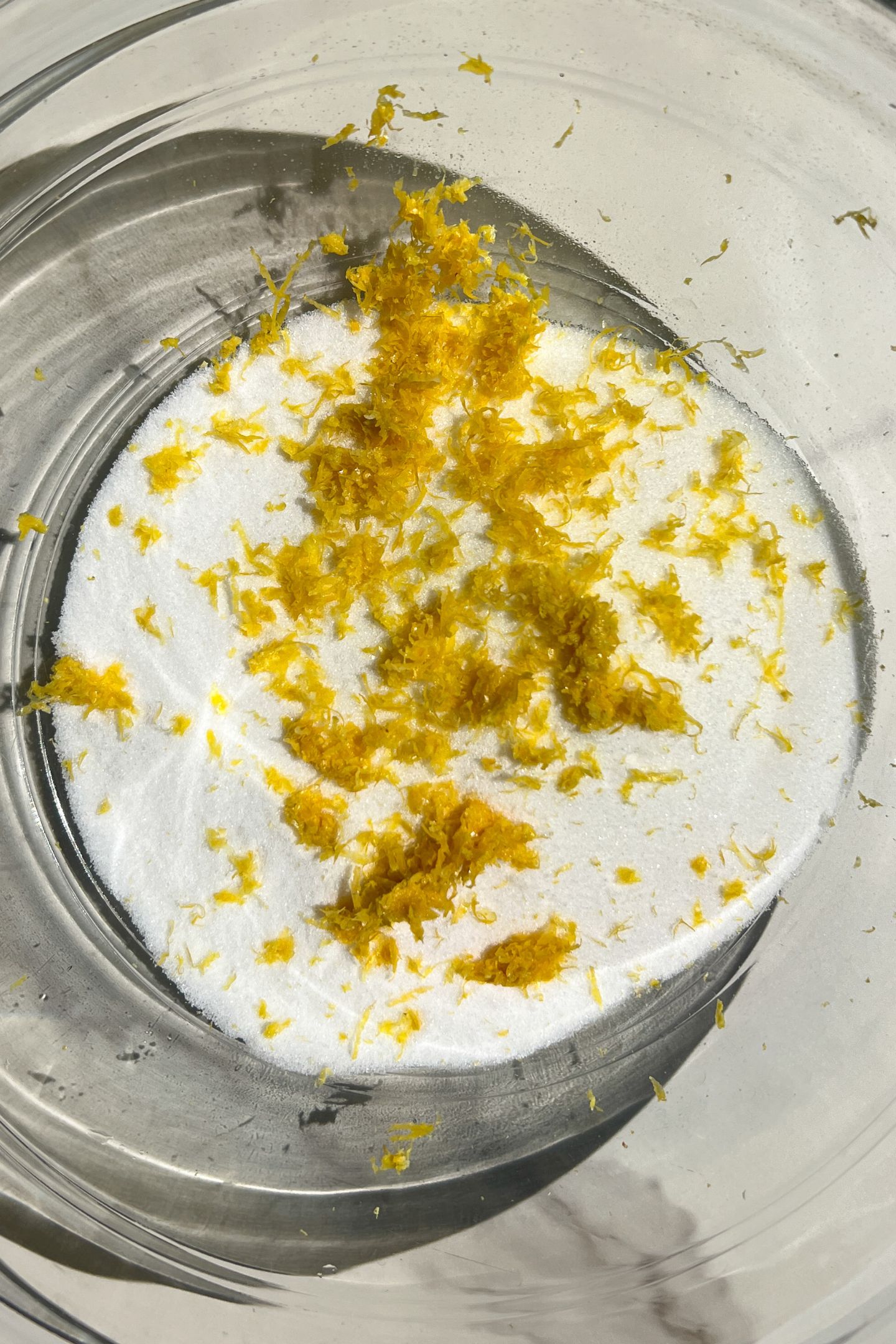 Lemon zest and sugar in a bowl.