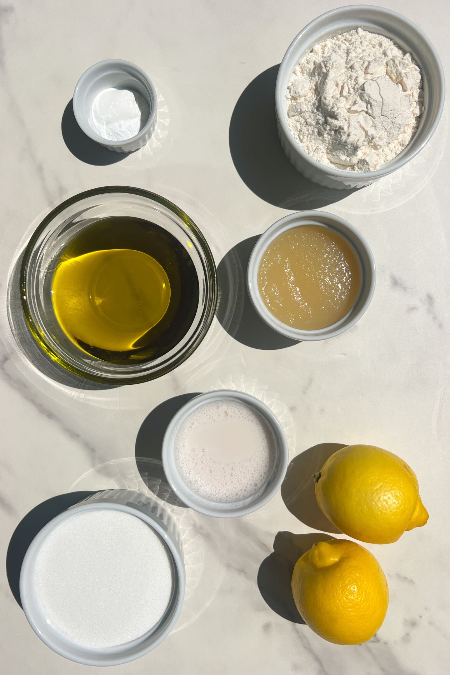 Ingredients measured out in bowls to make the olive oil cake.