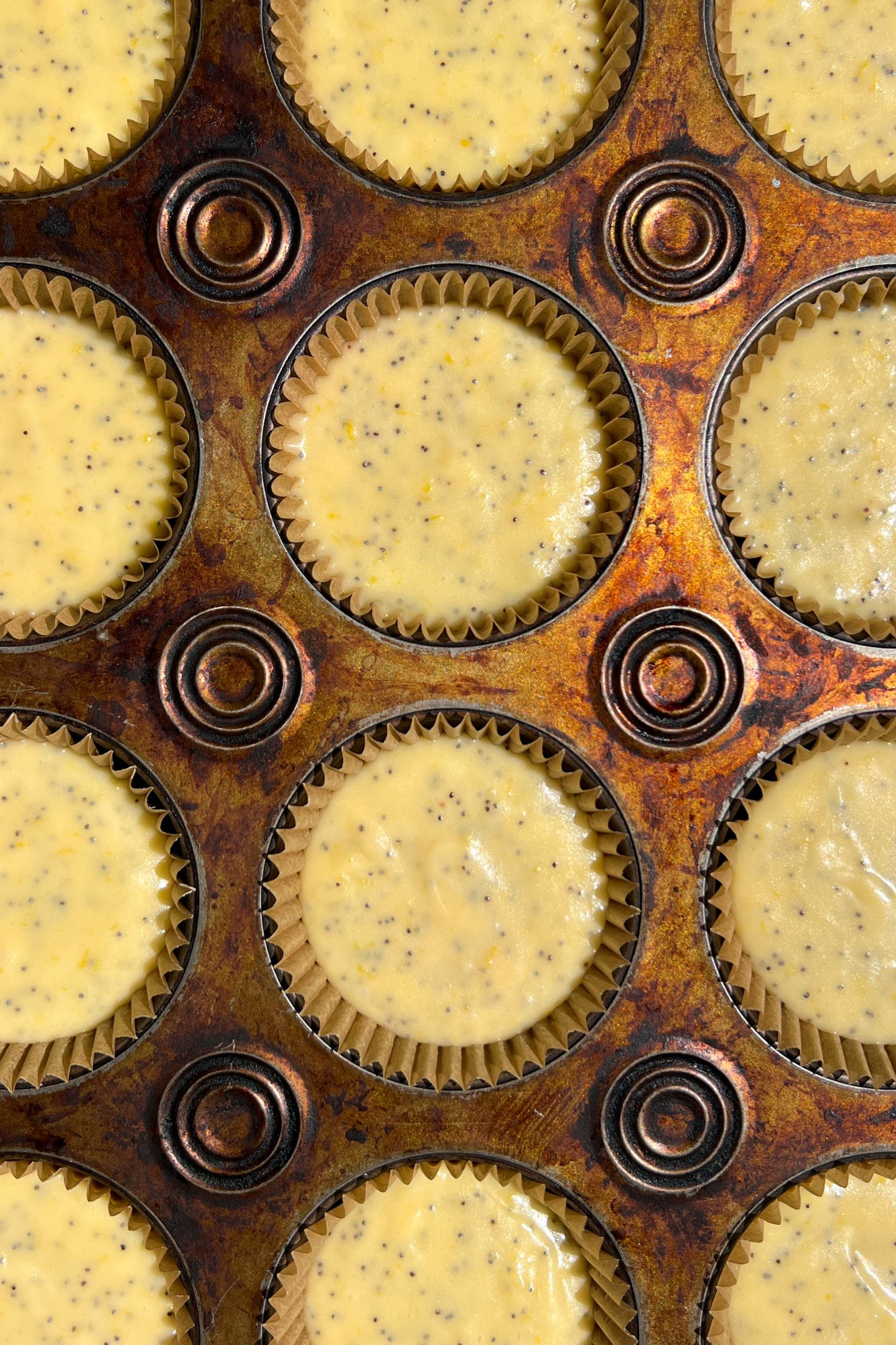Cupcake batter in a tray with liners.