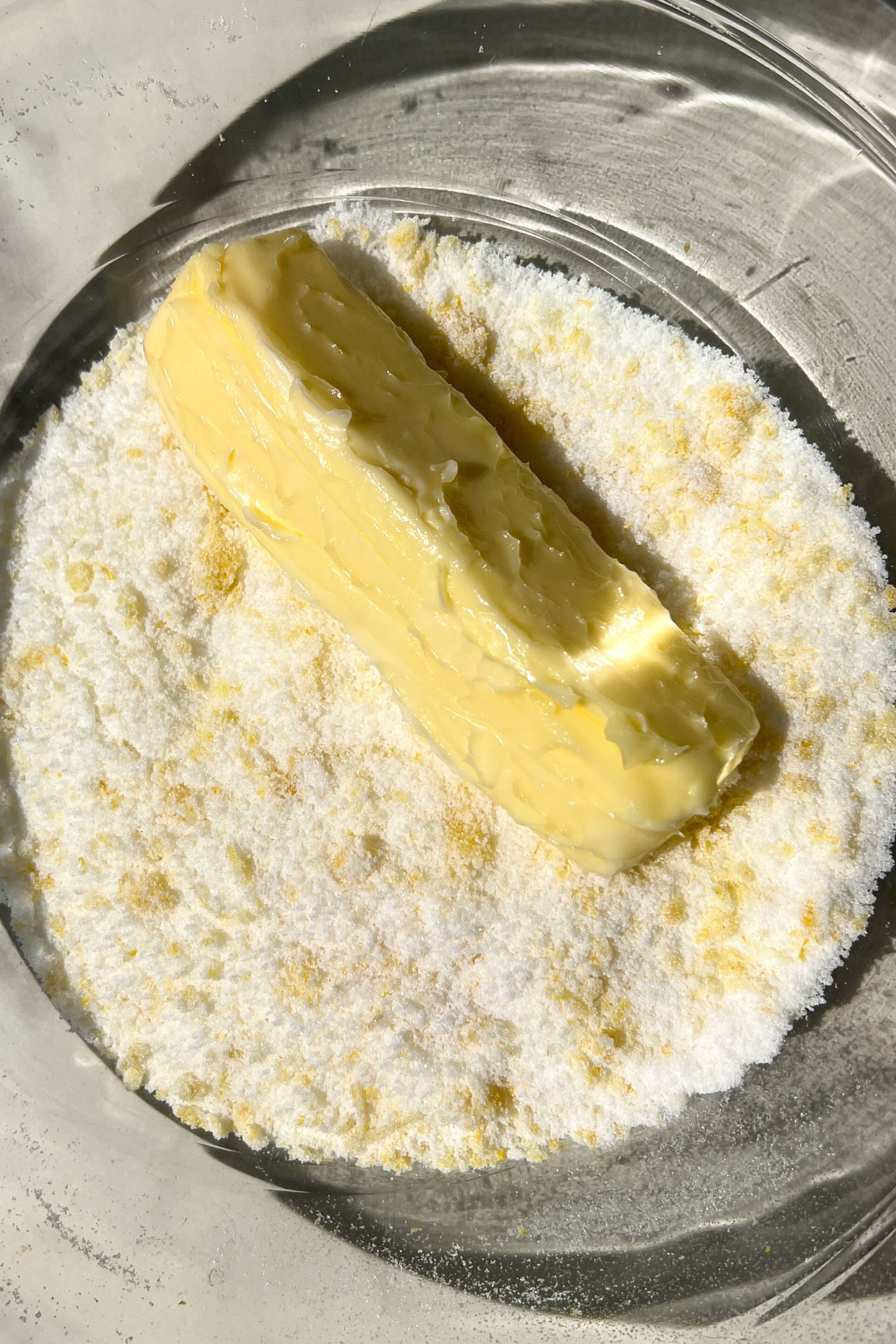 Lemon zest and granulated sugar in a mixing bowl with softened butter.