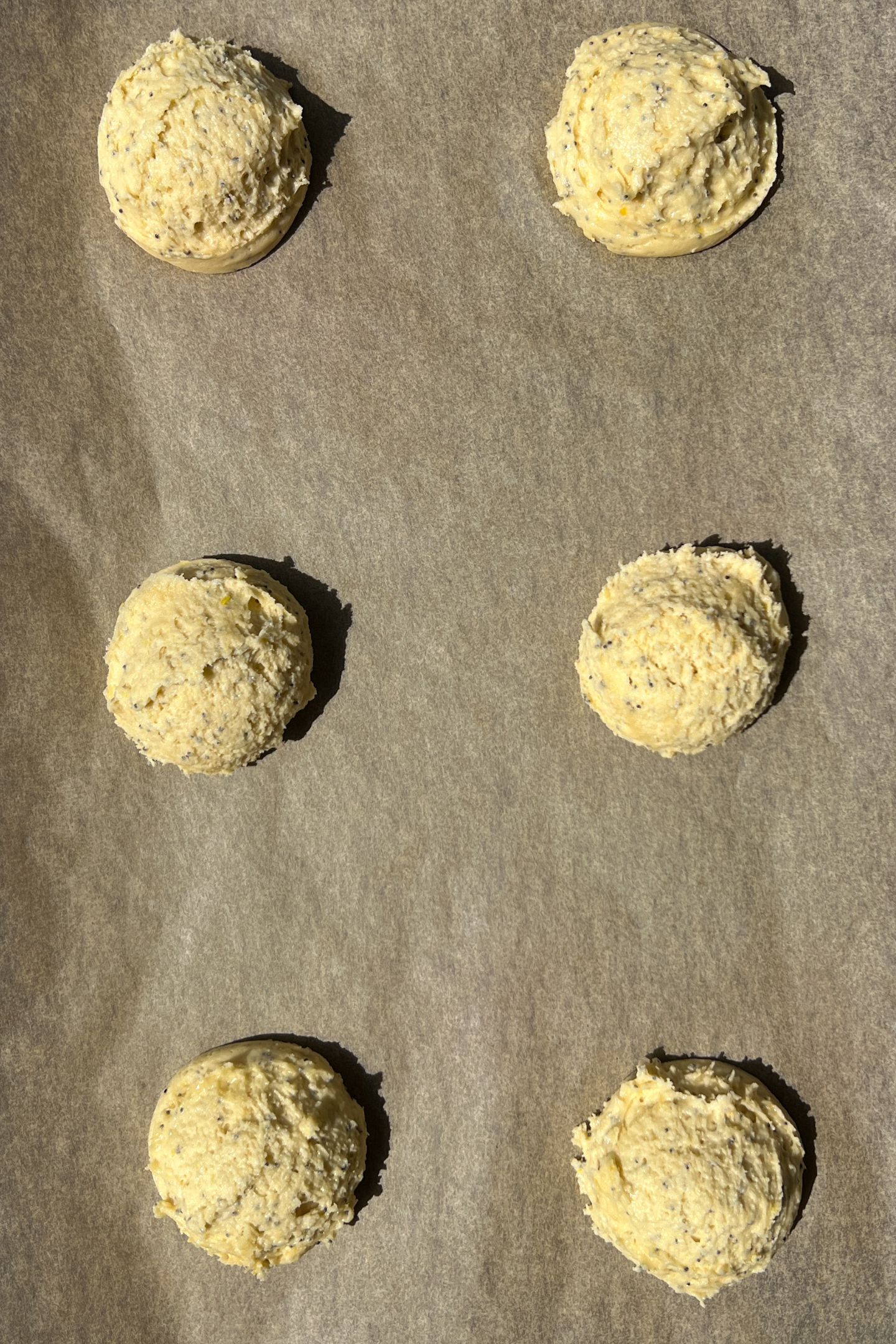 Cookie batter portioned on a cookie sheet.