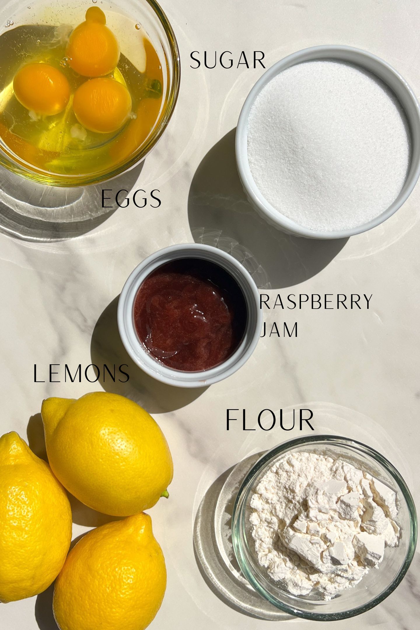Ingredients to make the raspberry lemon filling measured out in bowls.