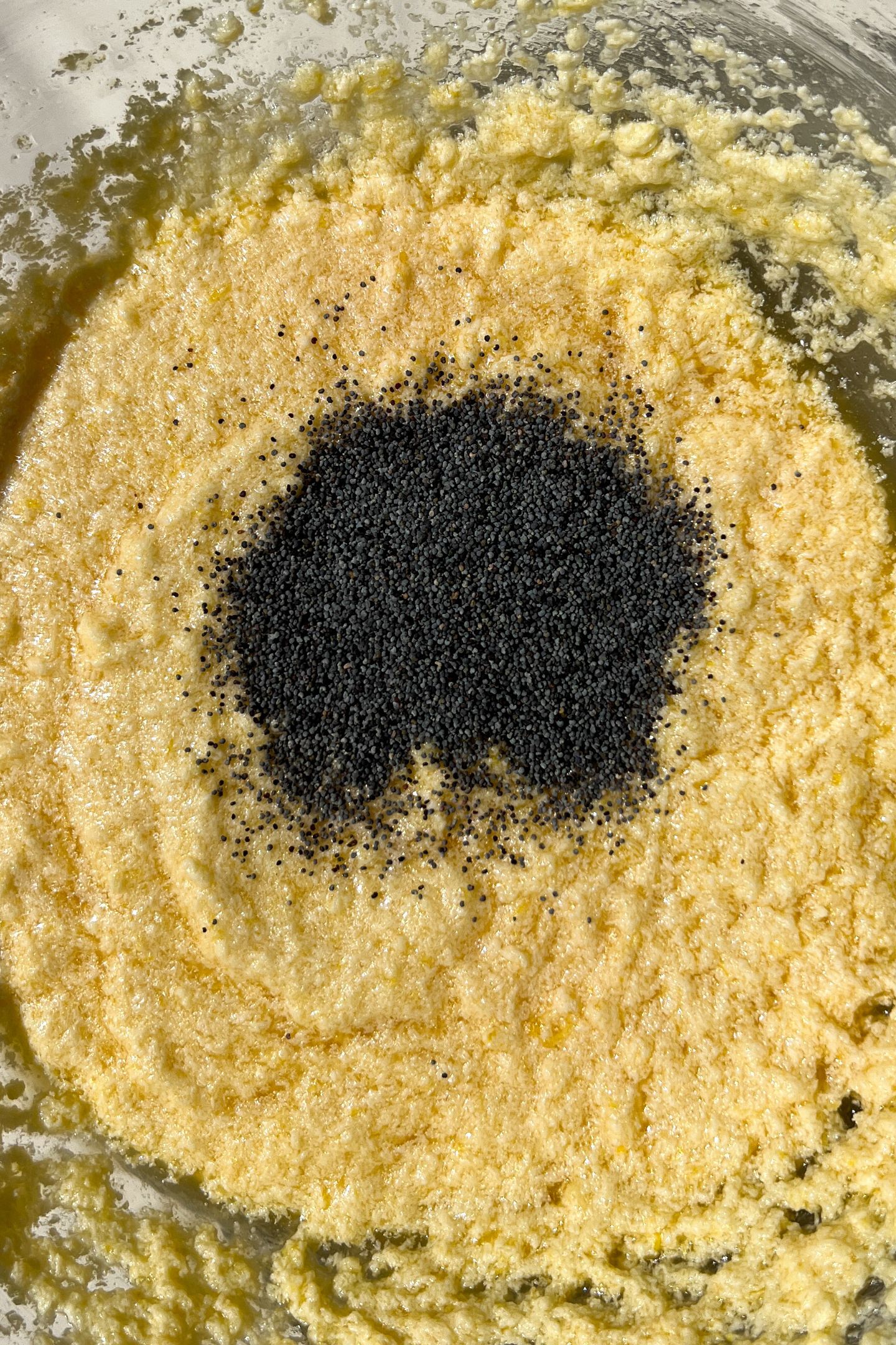 Adding the poppy seeds to the wet ingredients.