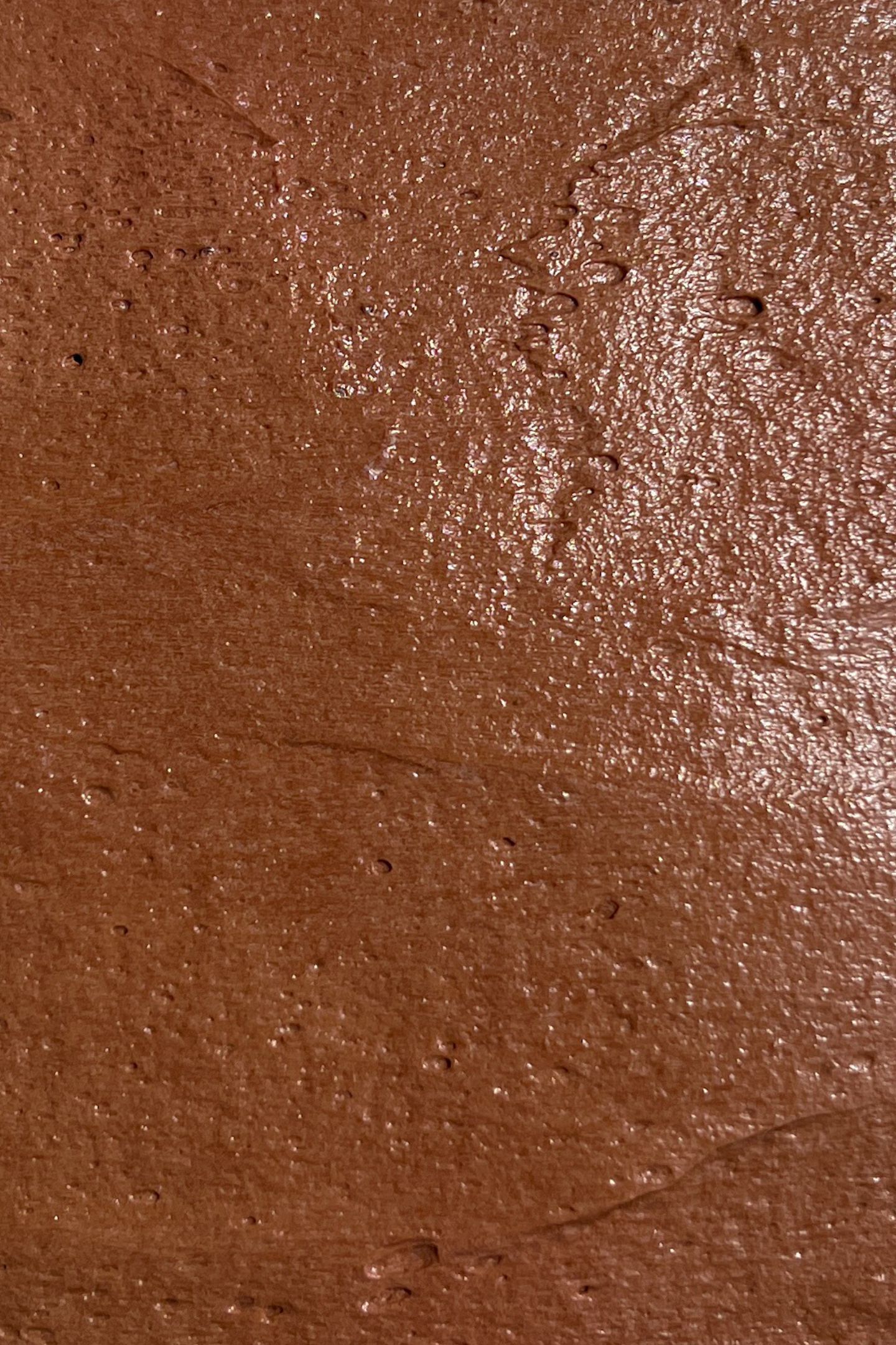Layer or chocolate cream cheese frosting on chocolate cake.