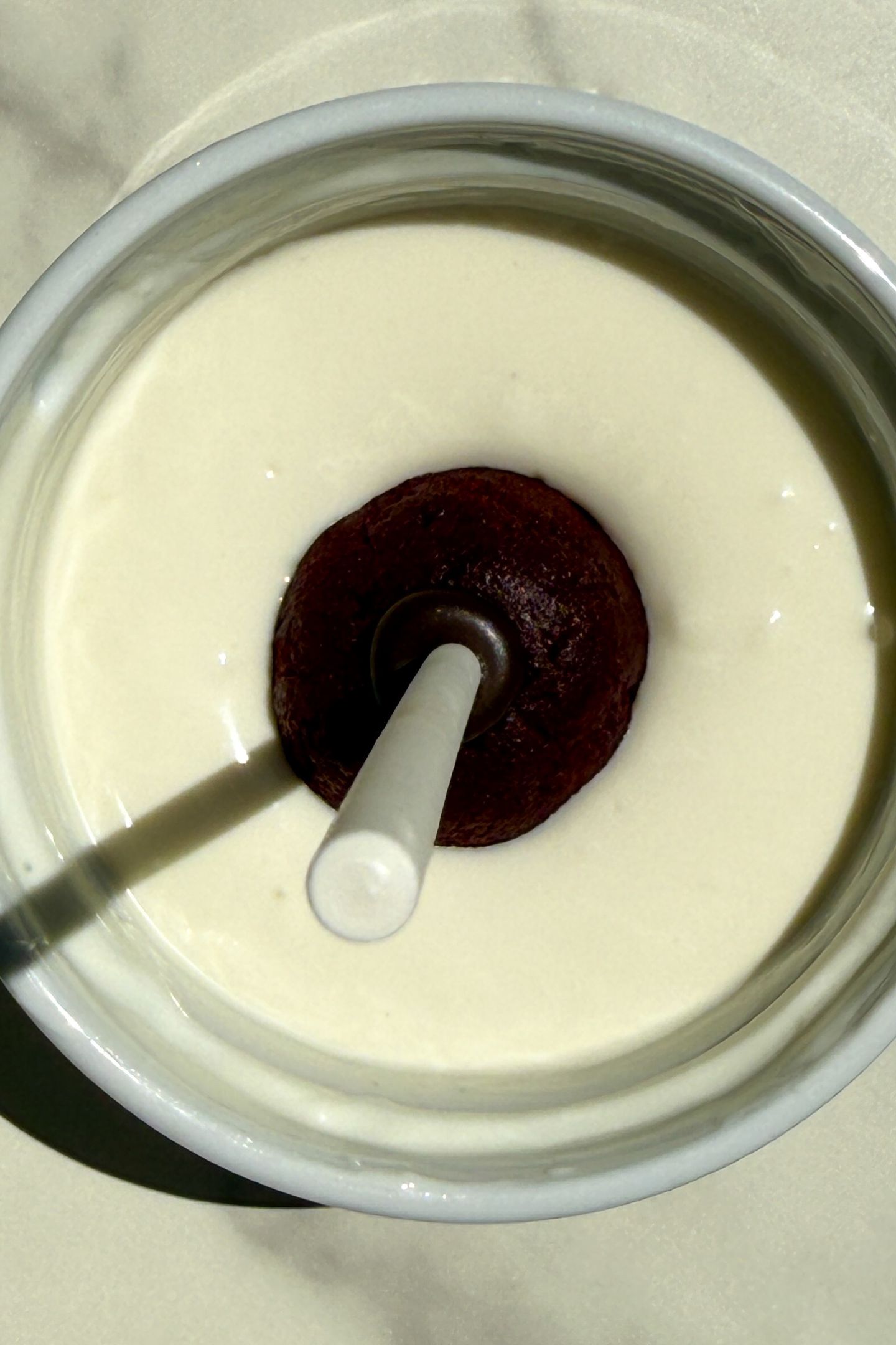 Dipping a cake pop in the white melted chocolate.