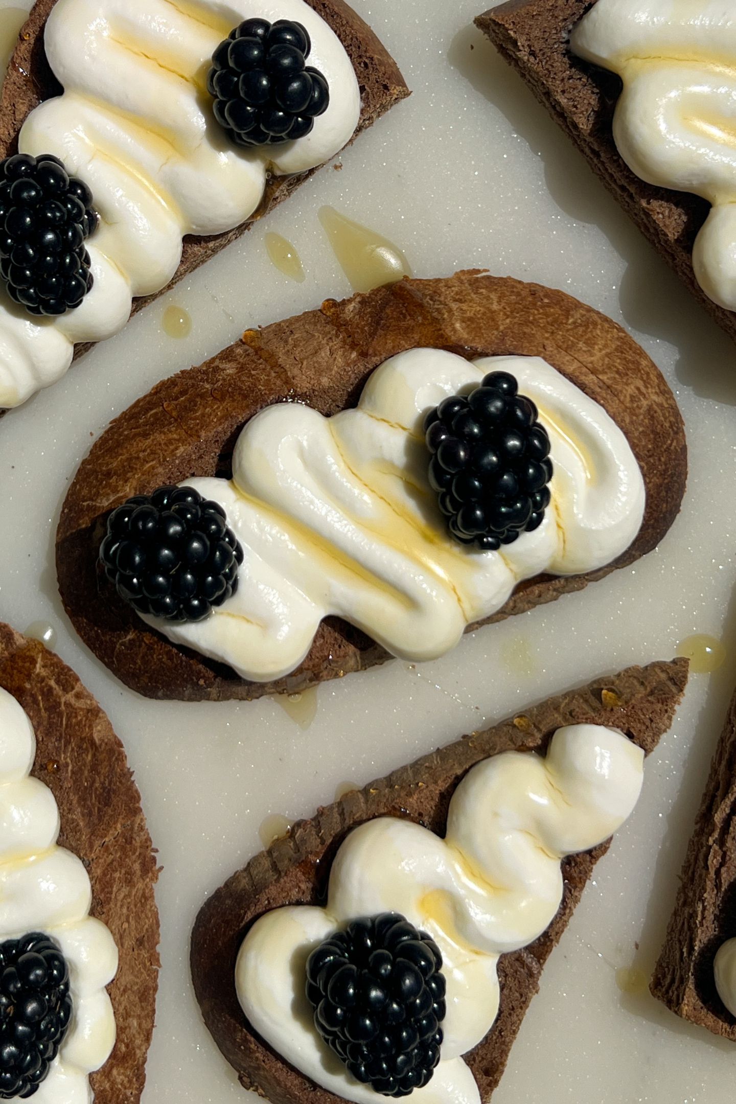 Goat cheese crostini topped with fresh blackberries.