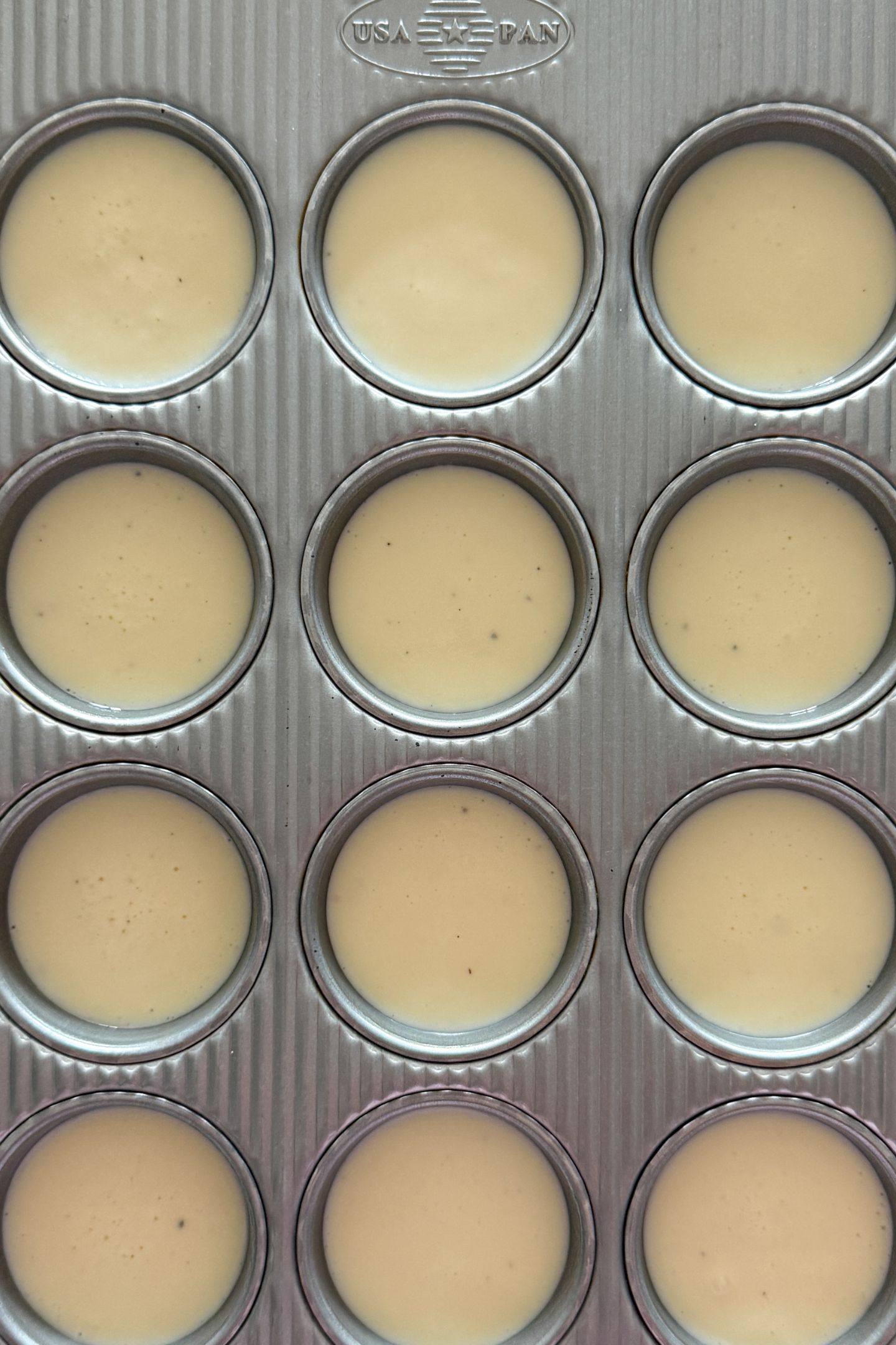 Egg White Bites batter poured in the muffin tin.