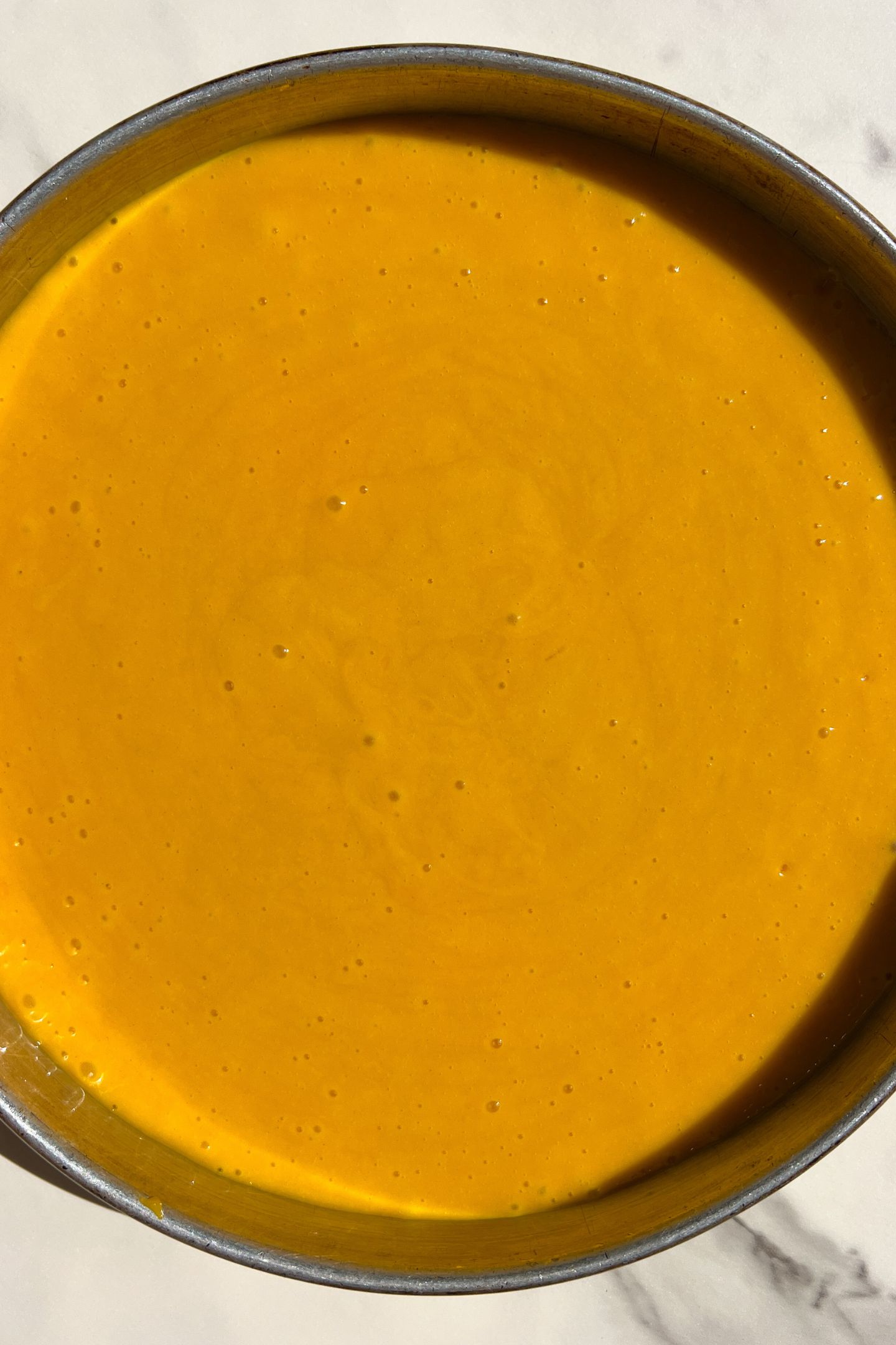 Cake batter in a prepared pan.