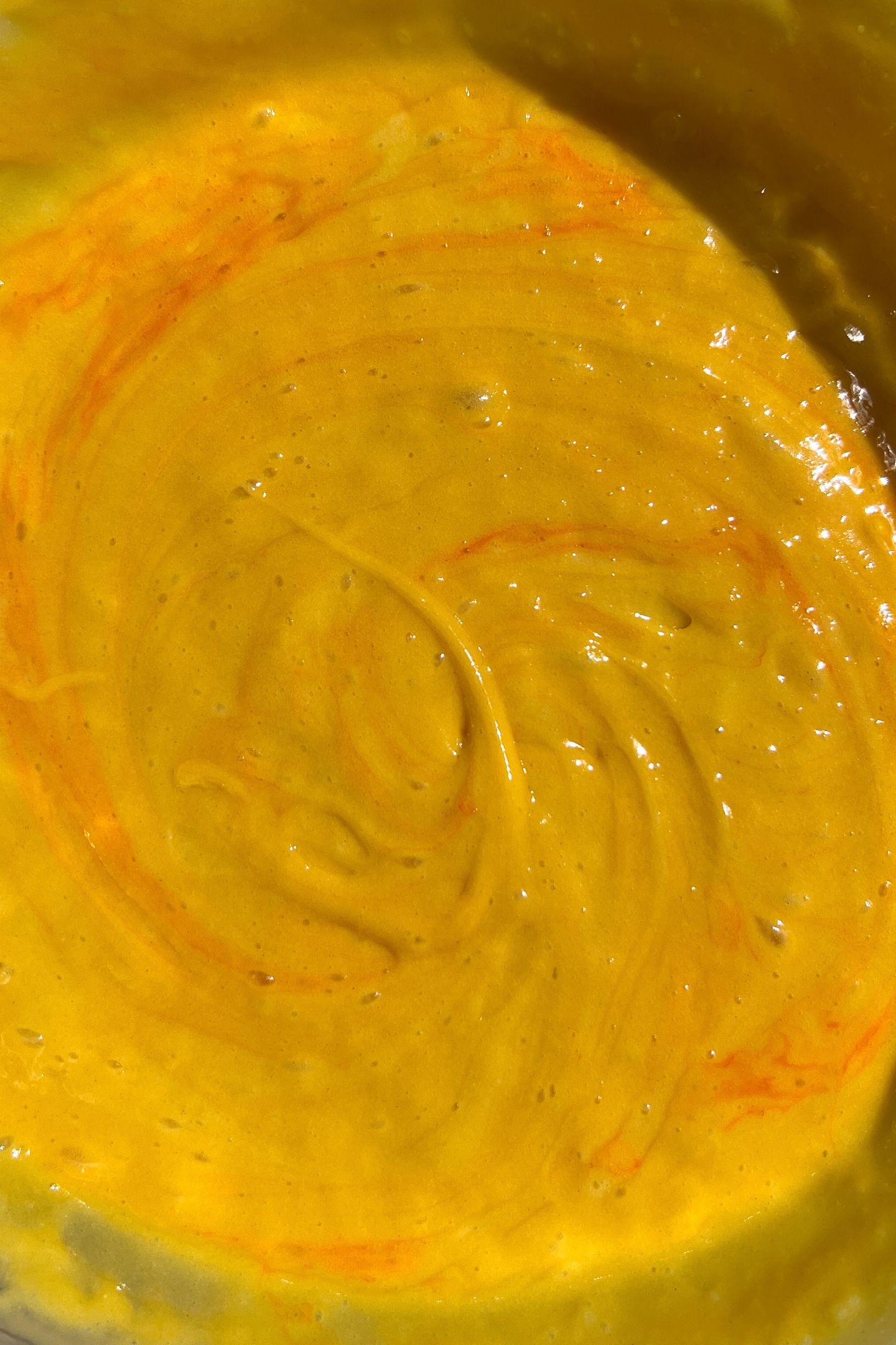 Making orange cake batter in a bowl.