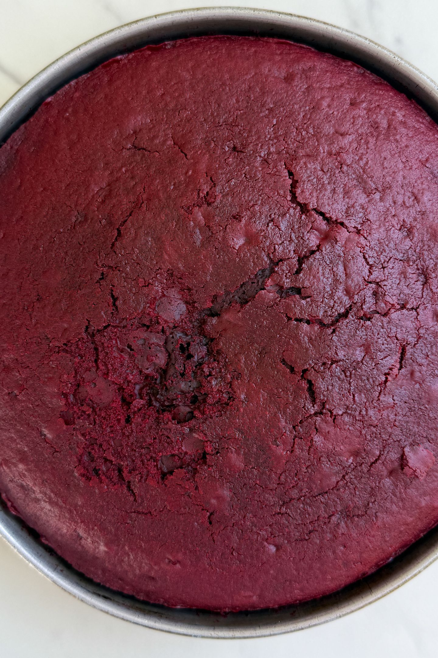 Baked red velvet cake in a pan.
