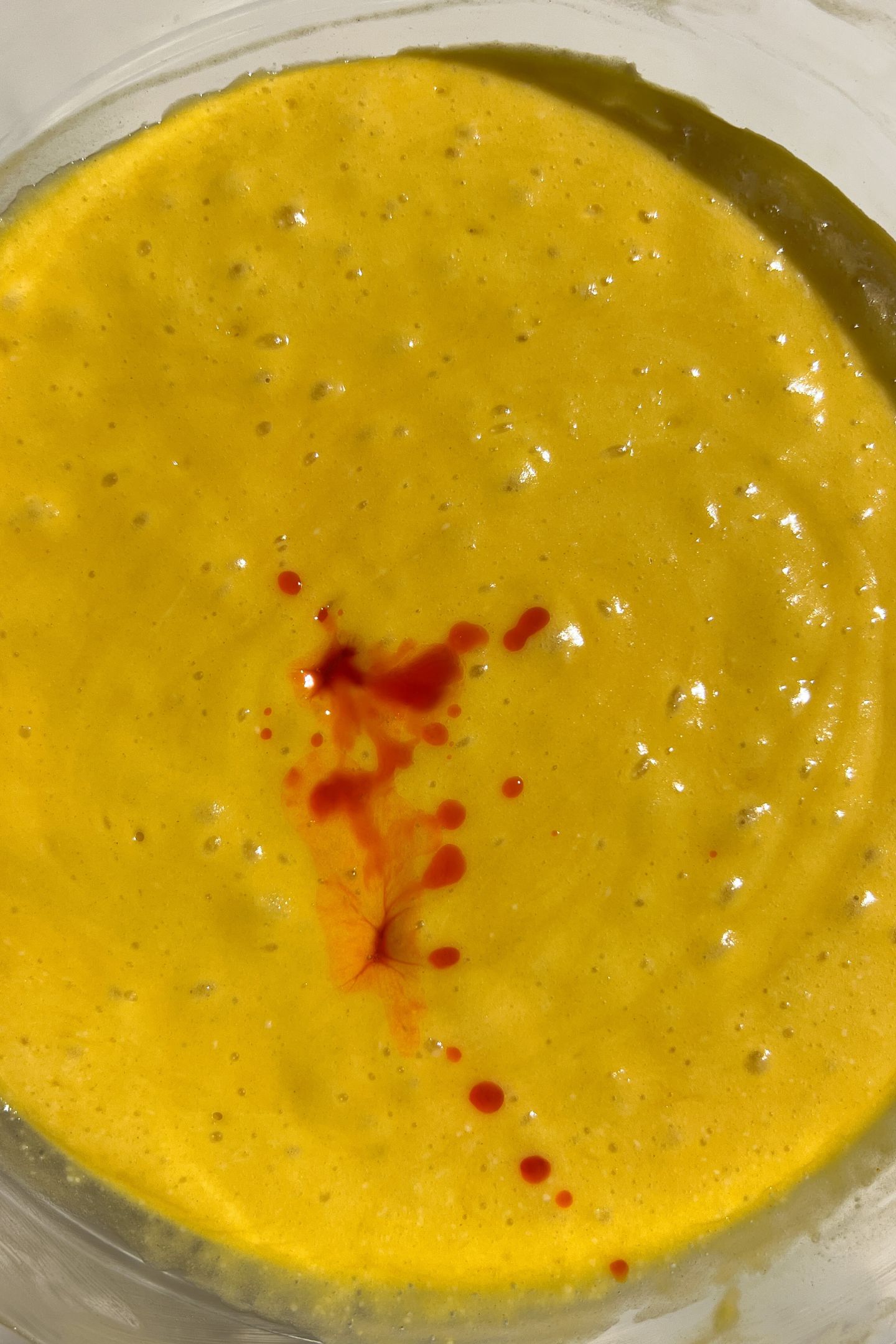 Making orange cake batter in a bowl.