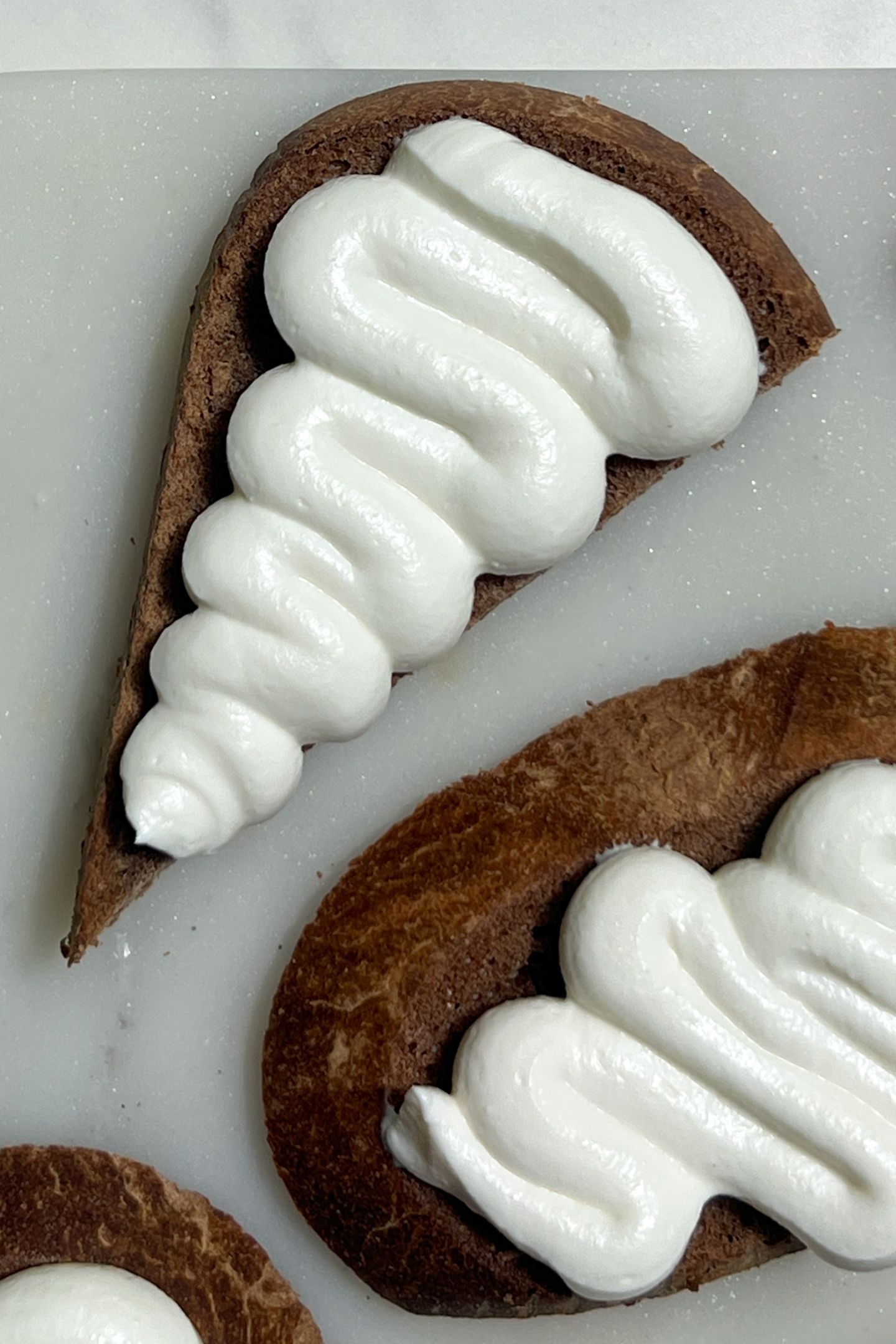 Crostini on a serving platter topped with goat cheese.