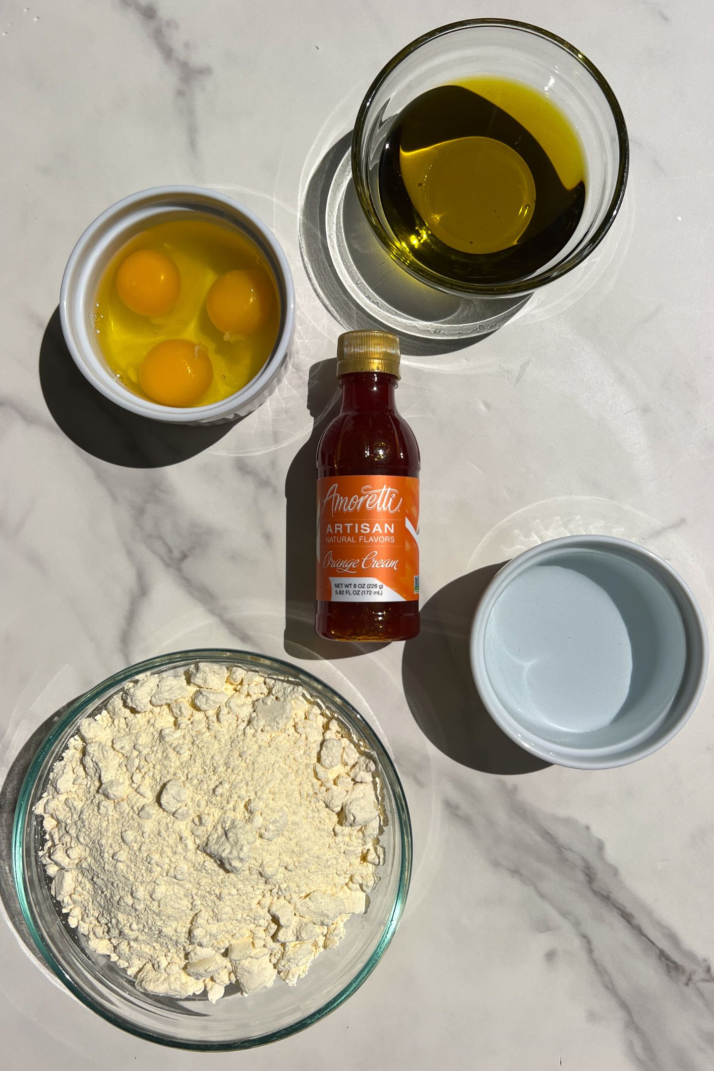 Ingredients measured out in bowls to make orange cake pops.