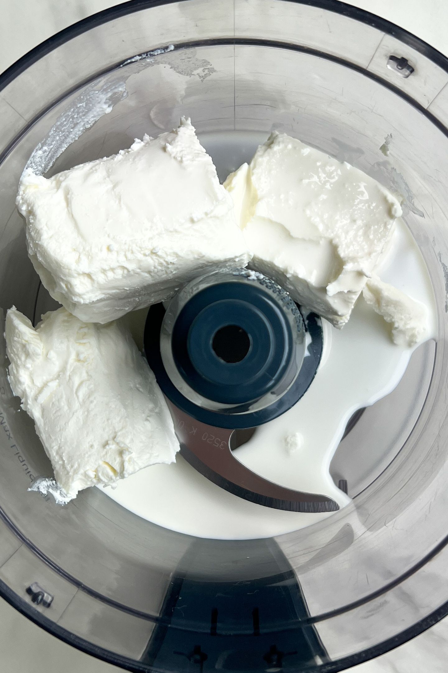 Goat cheese and heavy cream in processor.