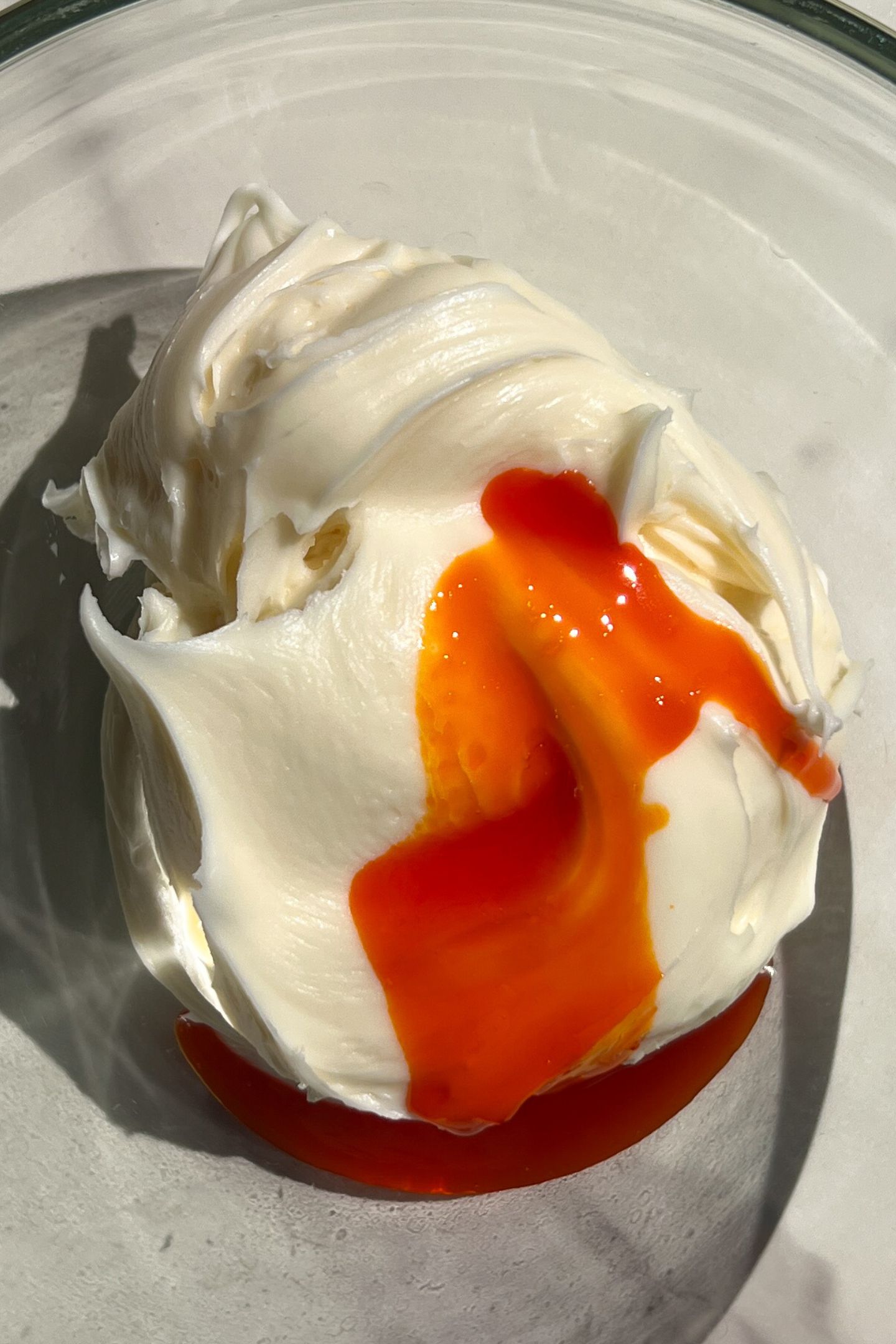 Making orange frosting in a bowl.