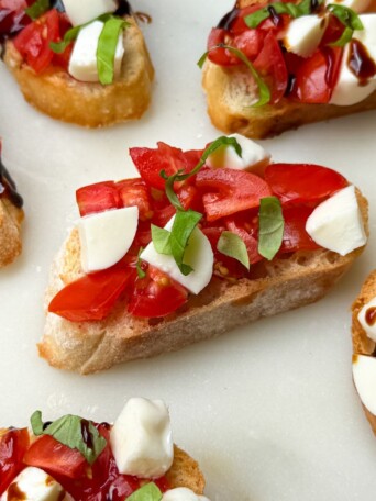 Caprese Crostinis with Balsamic Glaze on a serving platter.