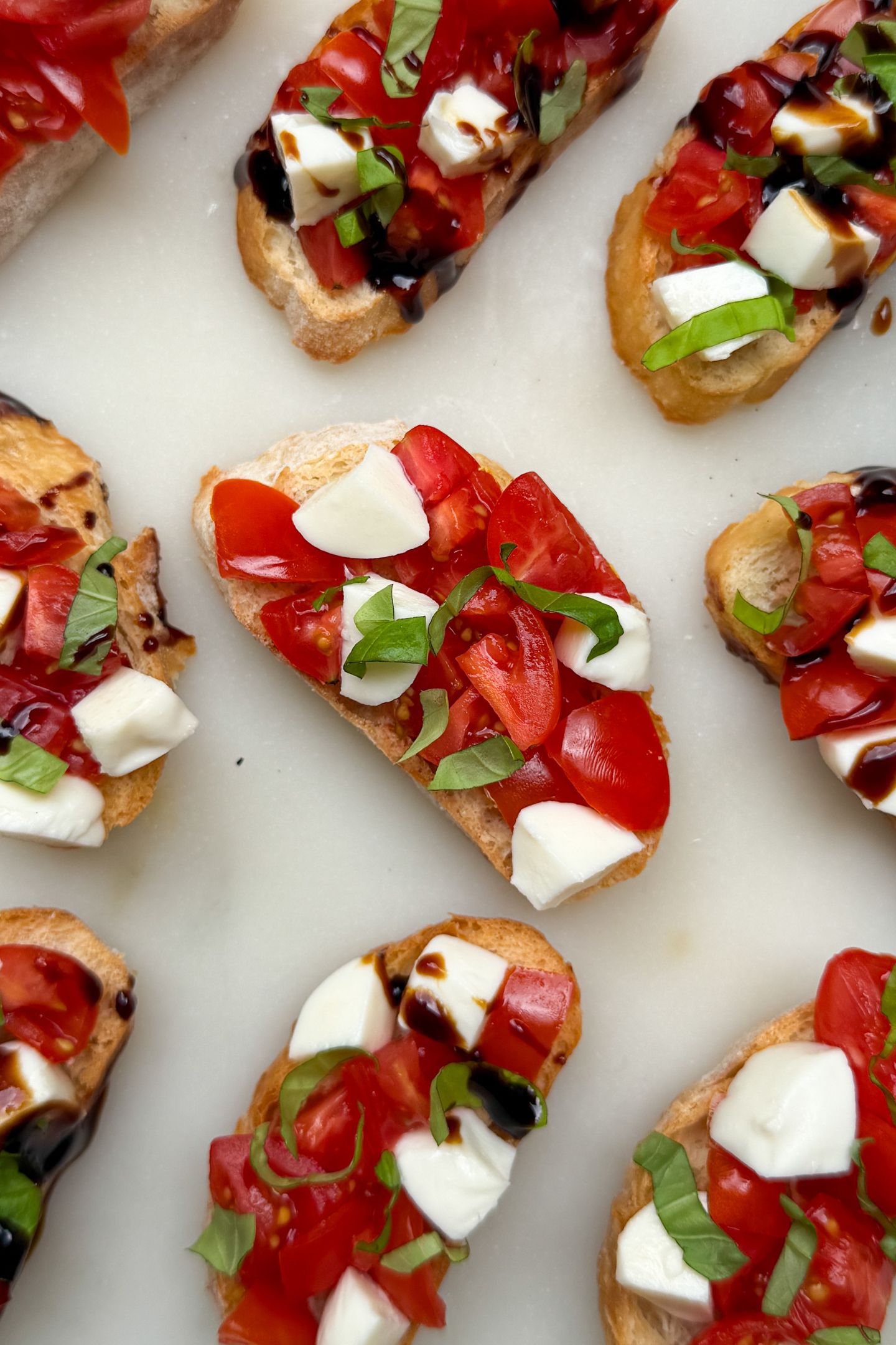 Prepared Caprese Crostinis on a platter.