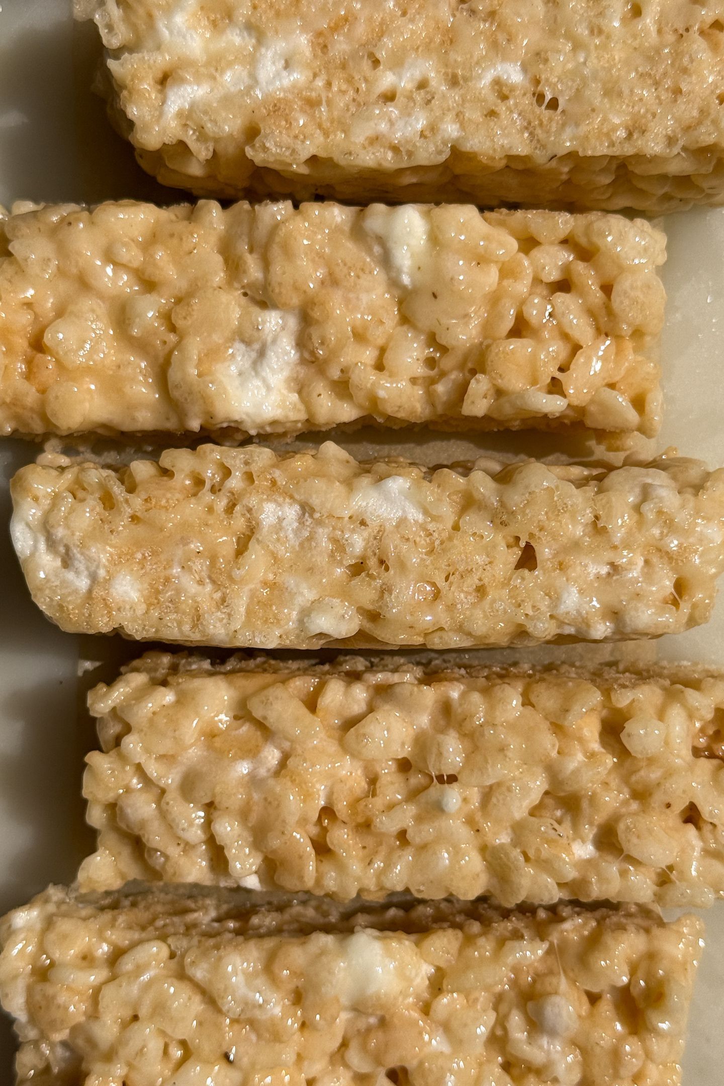 Sliced bars of Rice Krispie treats with mini marshmallows.