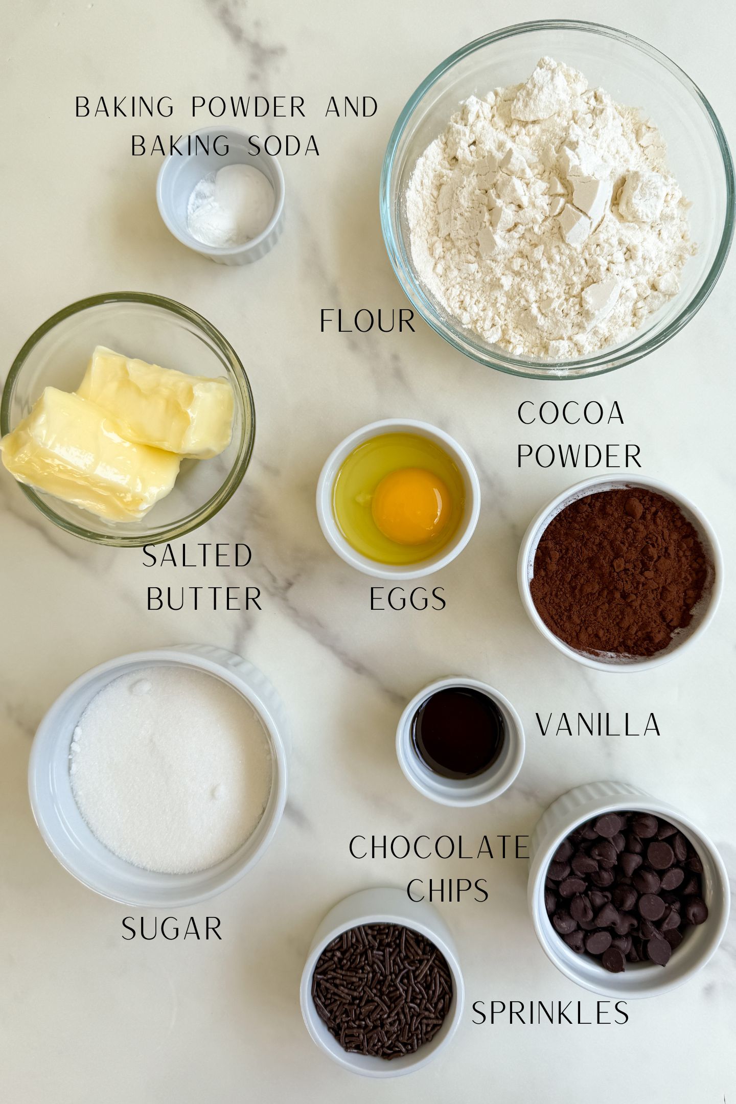 Ingredients measured out in bowls to make these chocolate cookies with chocolate frosting.