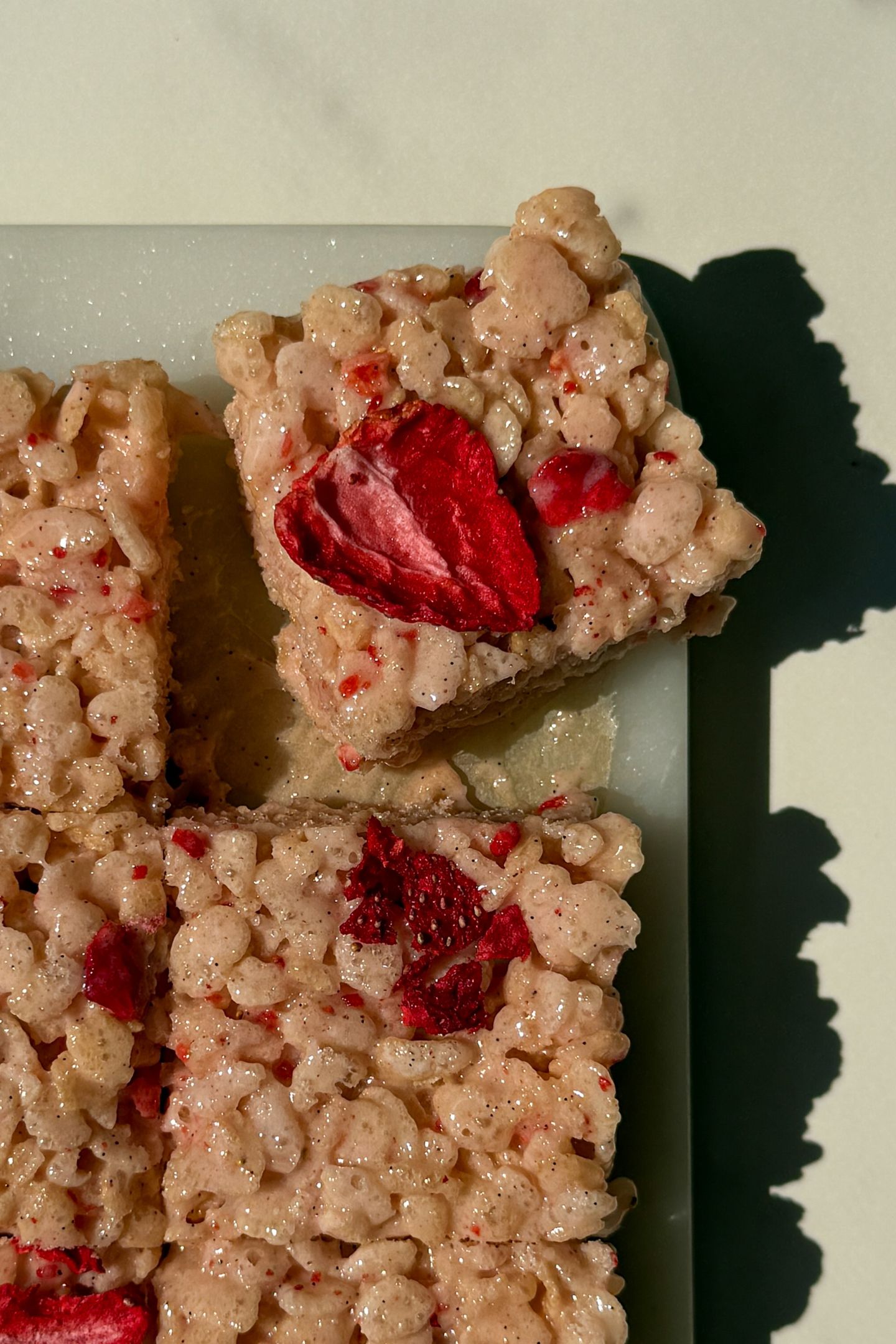 Rice Krispie Treats sliced on a platter to serve.