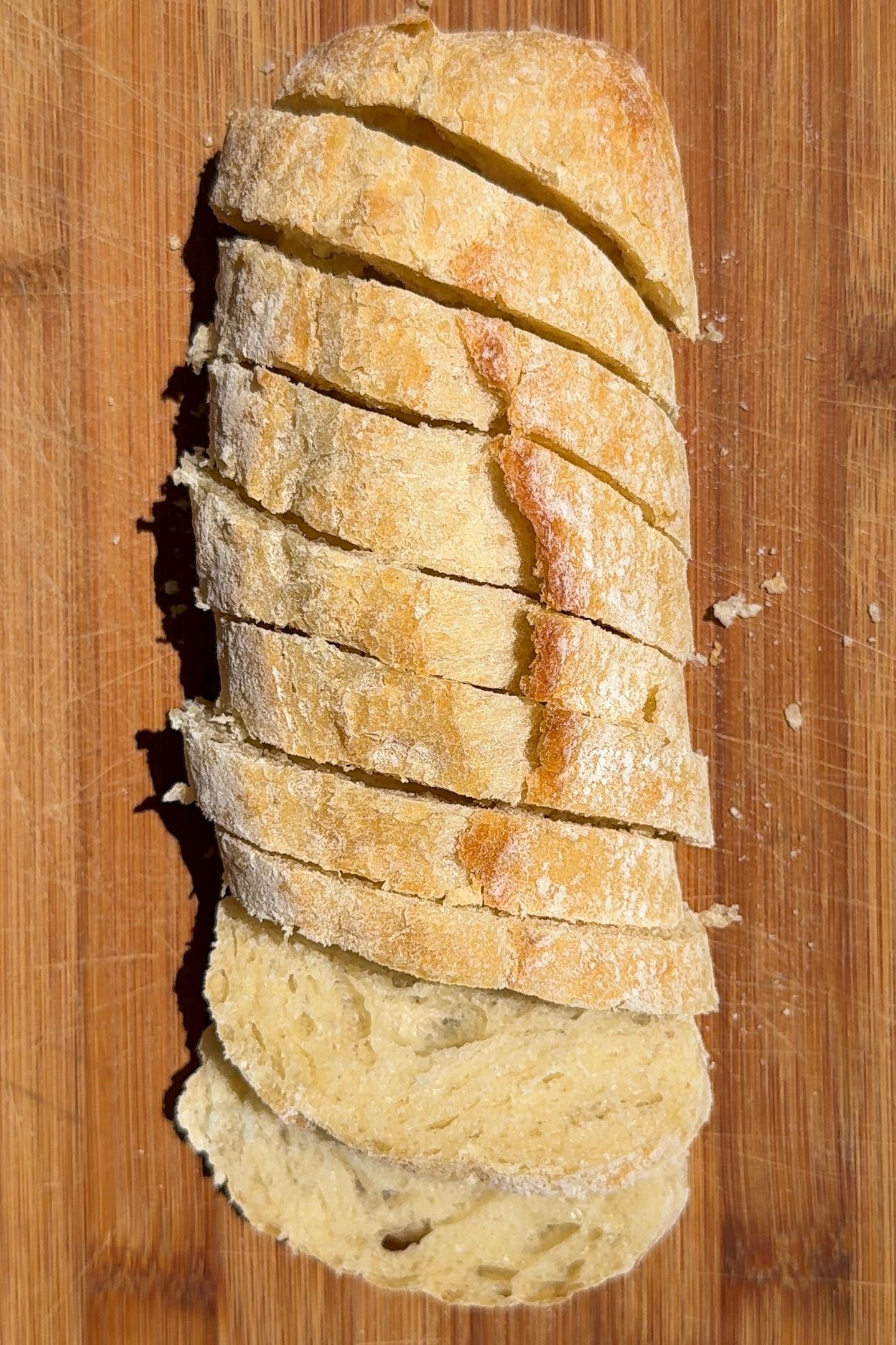 Sliced ciabatta loaf on a cutting board.