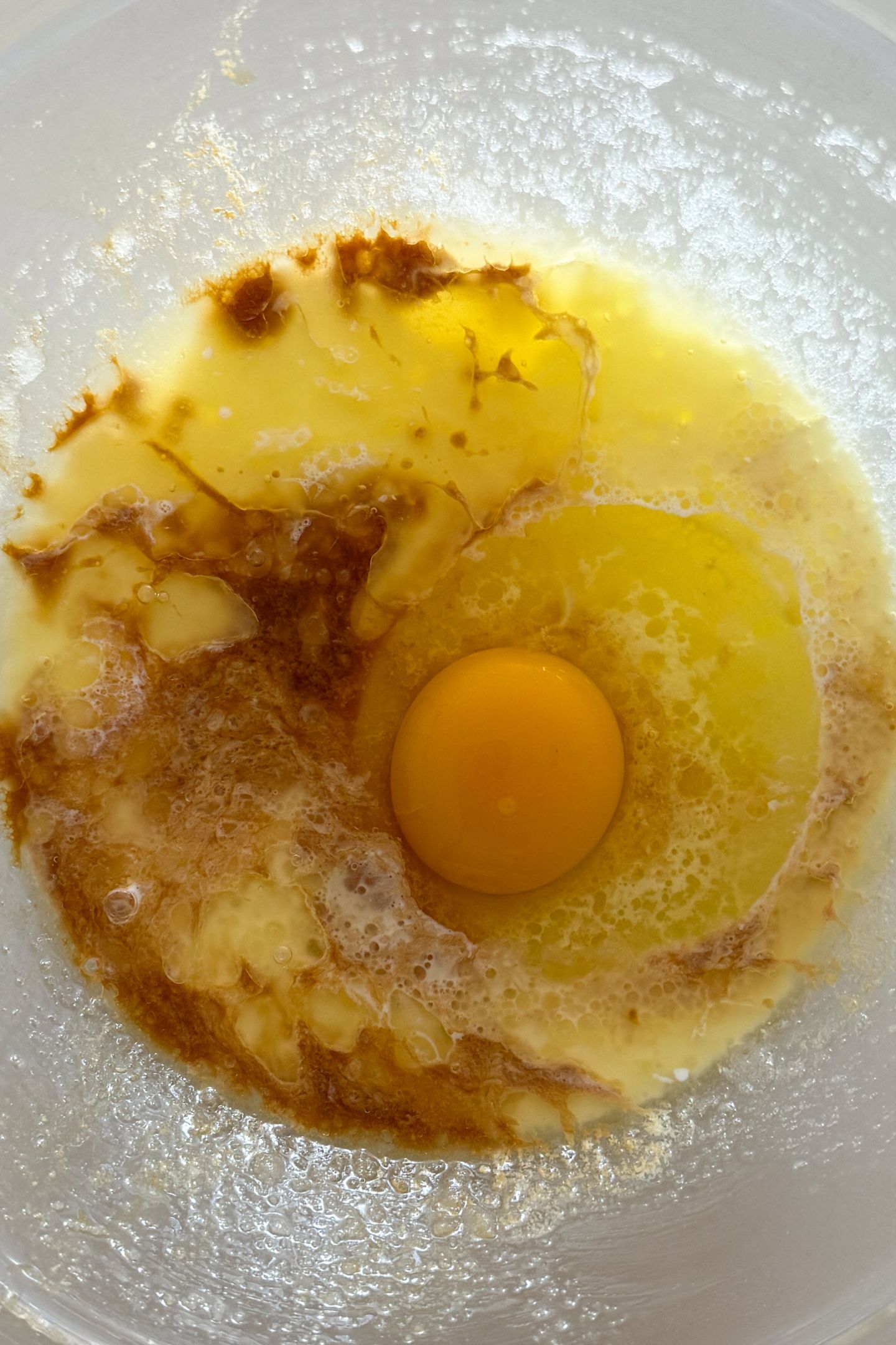 Adding the egg and vanilla to the mixture.