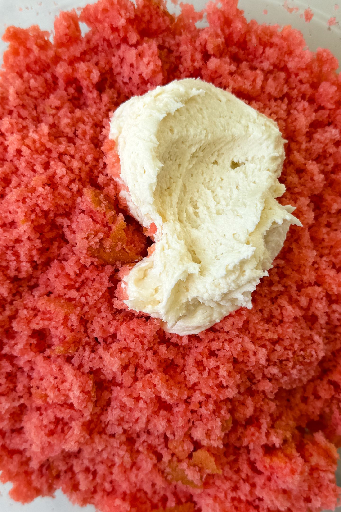 Cake crumbles in a bowl with frosting.