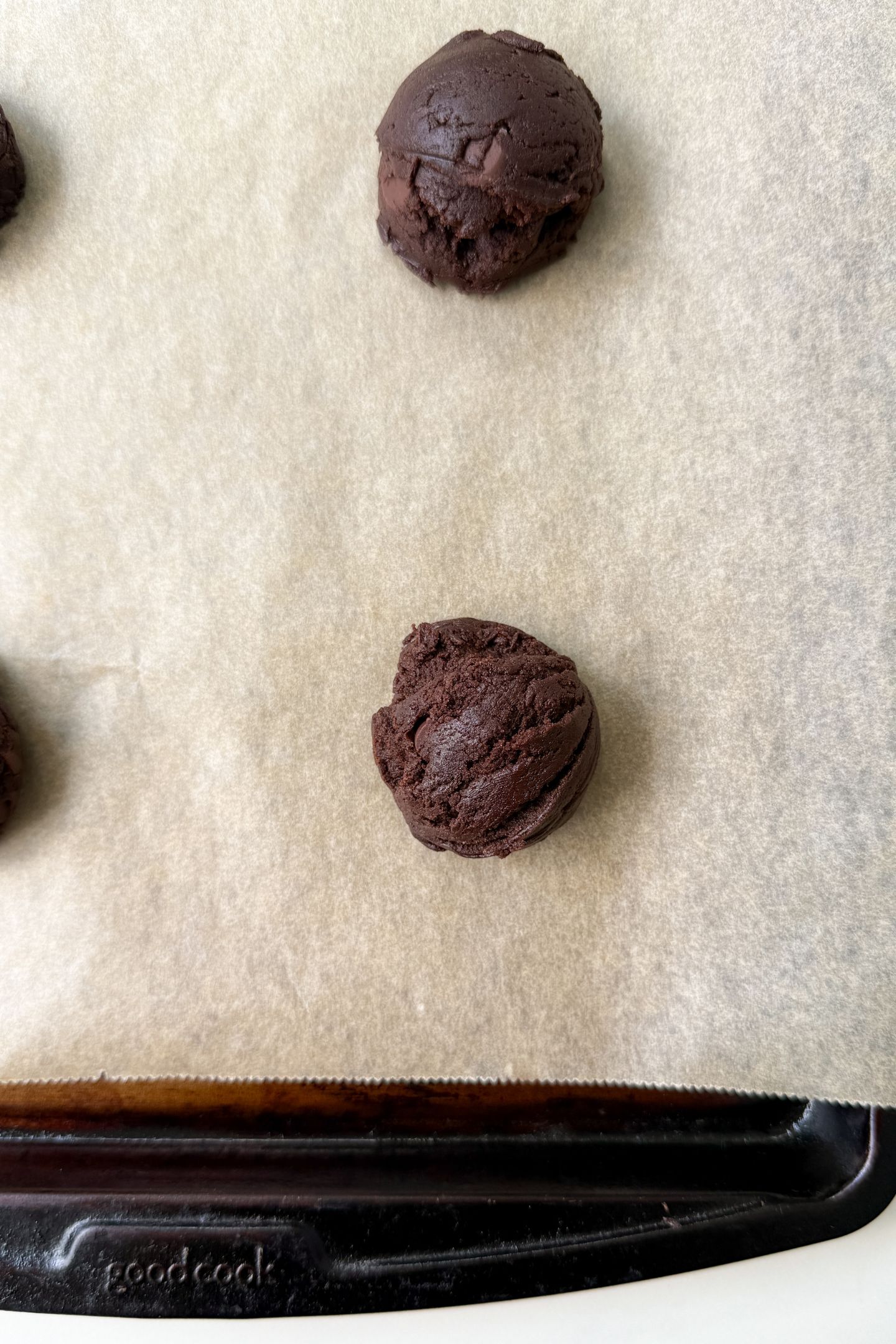 Cookie dough on a baking sheet lined with parchment paper.