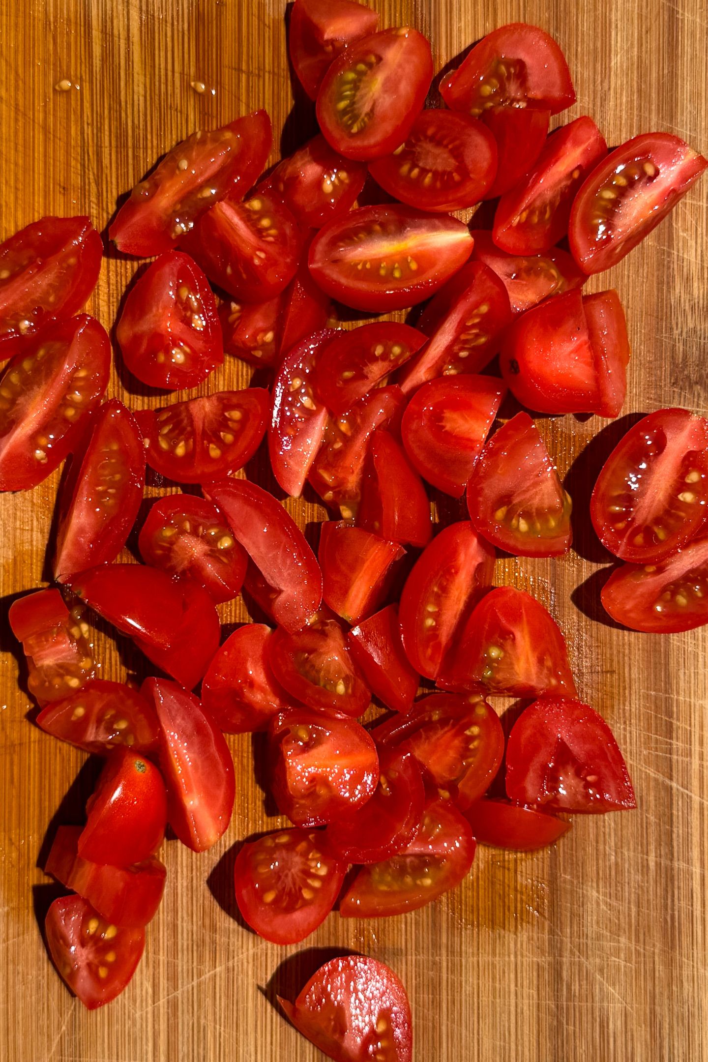 Sliced tomatoes on a cutting board.