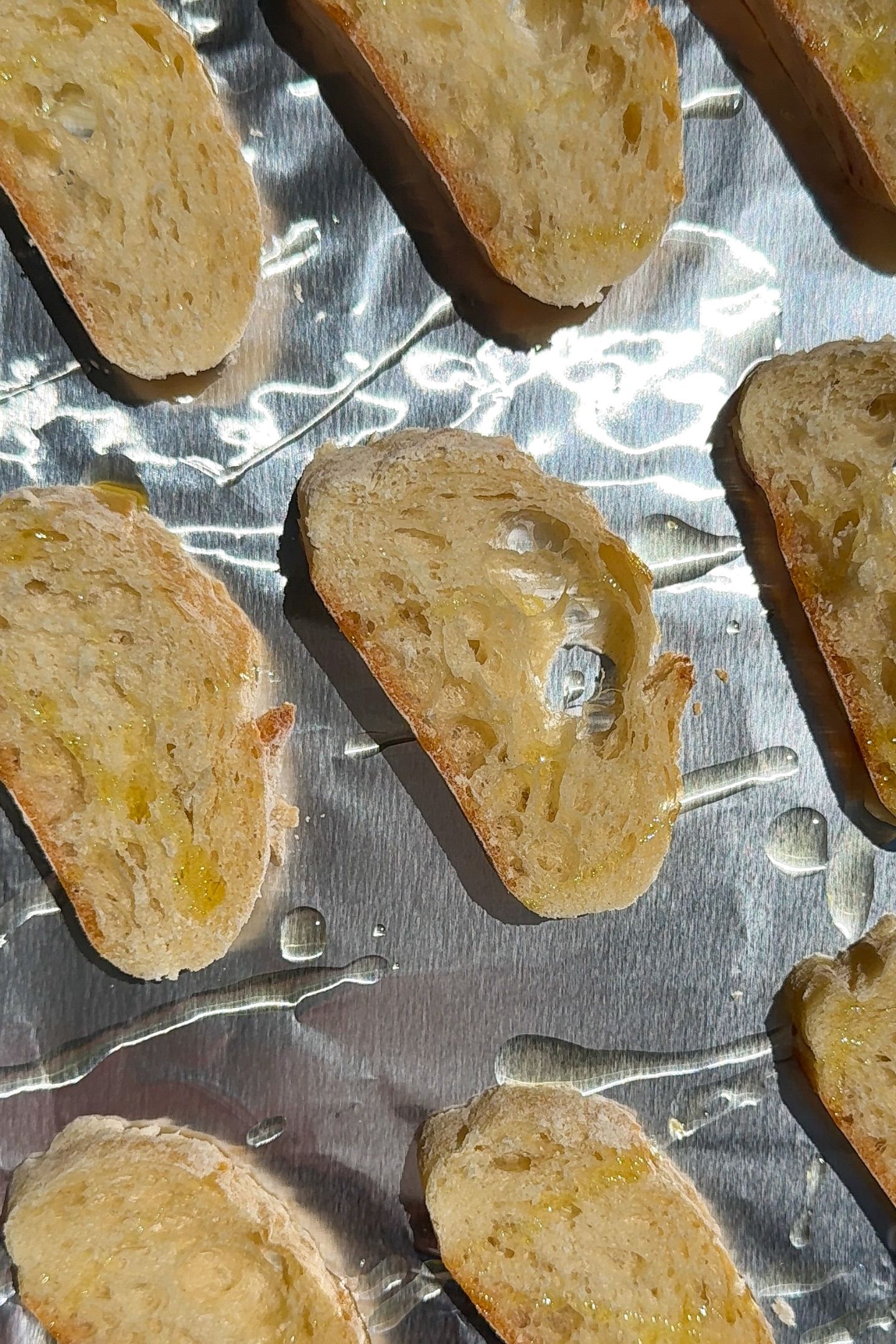 Crostini's on a prepared baking sheet lined with aluminum foil.