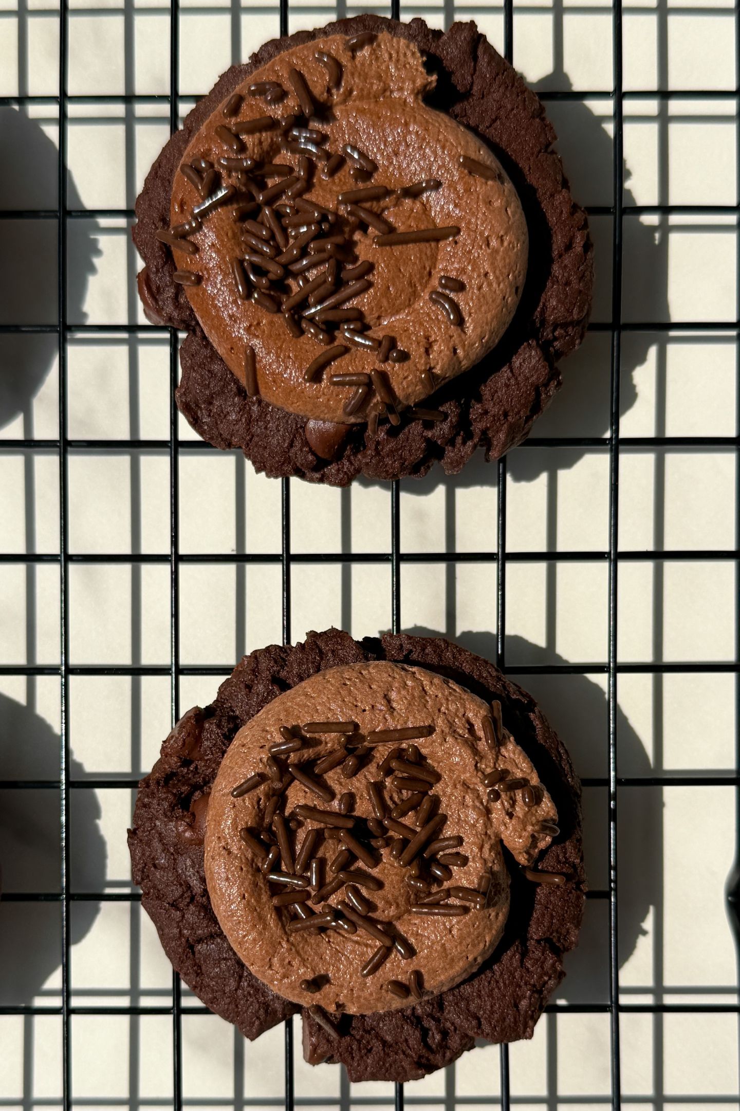 Cookies frosted on a cooling rack.