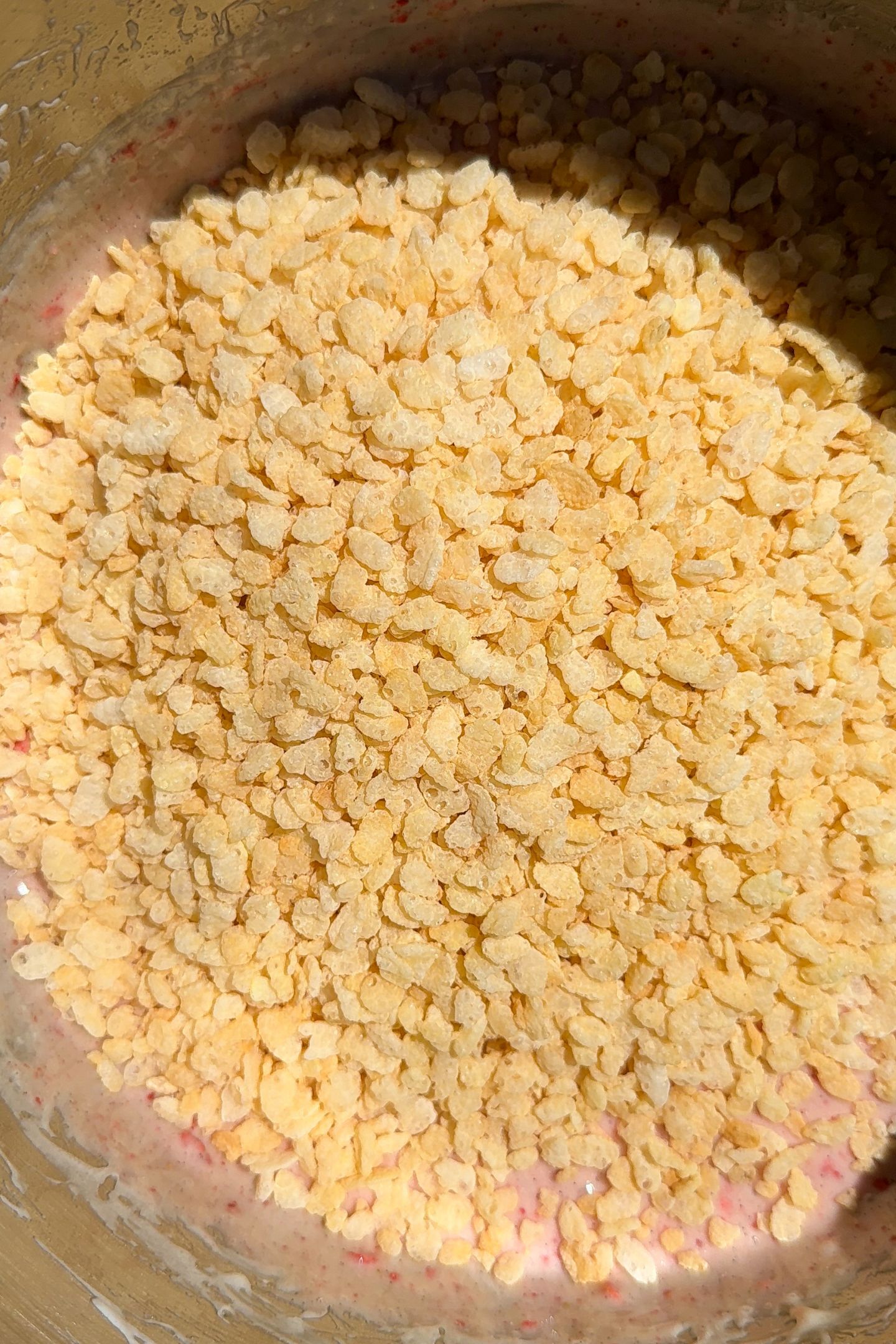 Rice cereal added to the marshmallow mixture in pan.