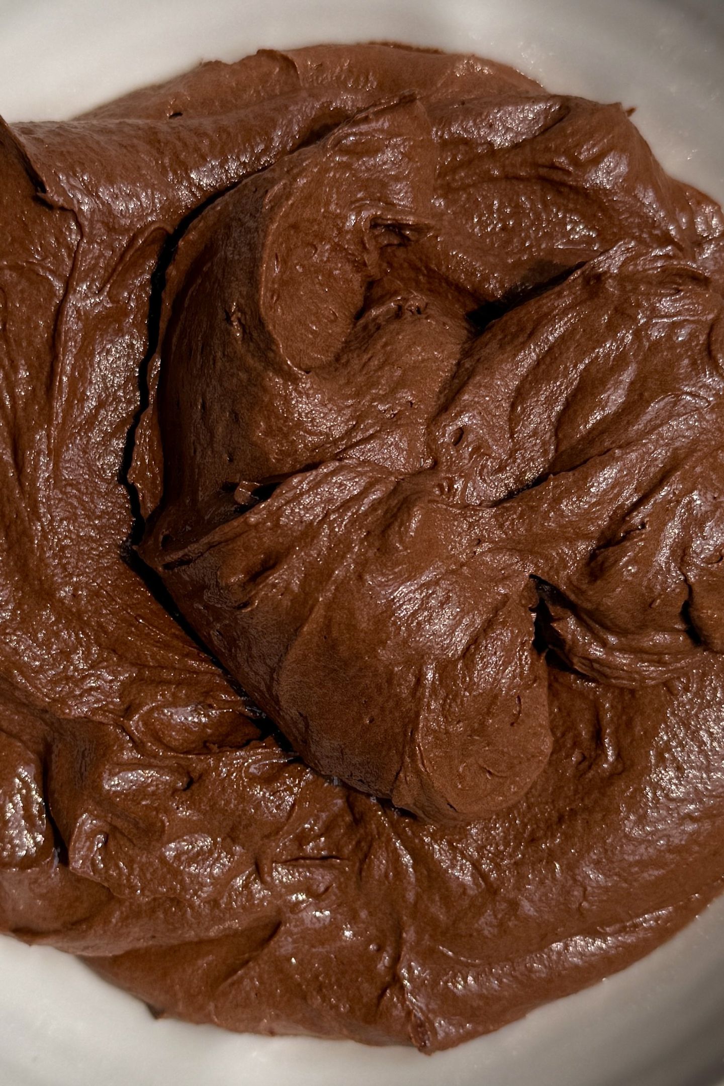 Chocolate buttercream frosting in a bowl.
