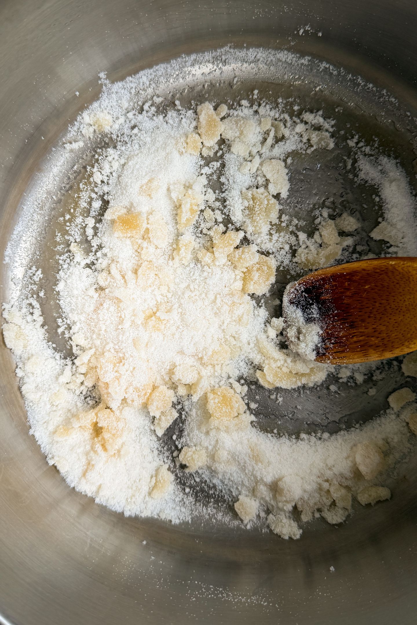 Melting the granulated sugar in a stainless steel pot.