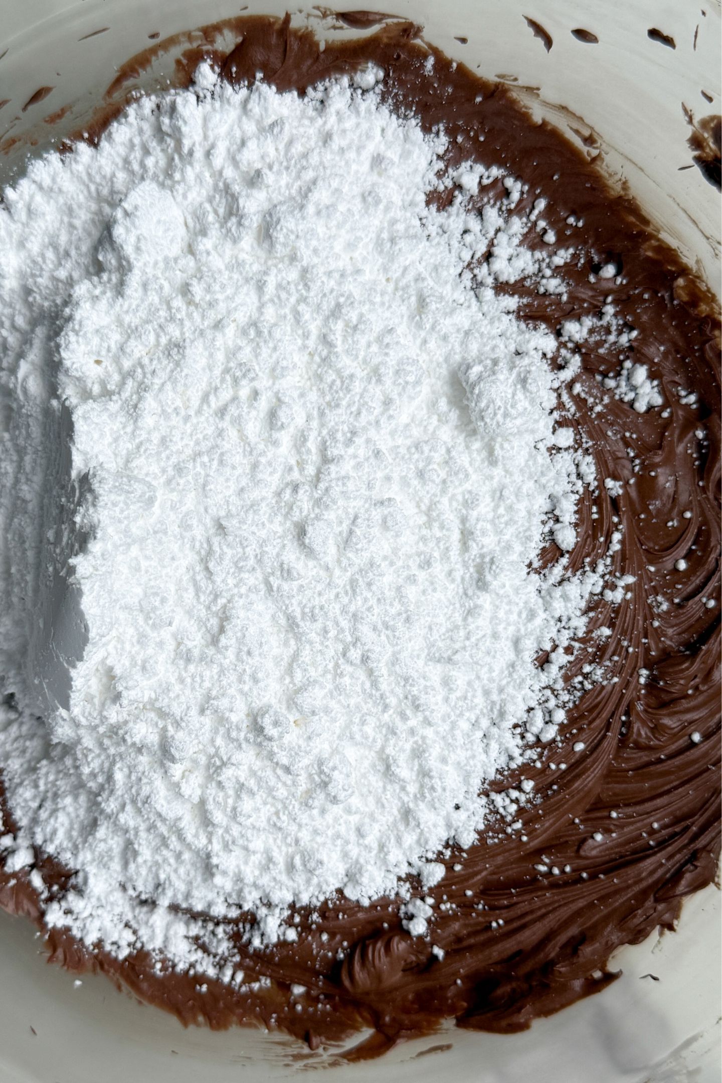 Powdered sugar being added to the bowl.