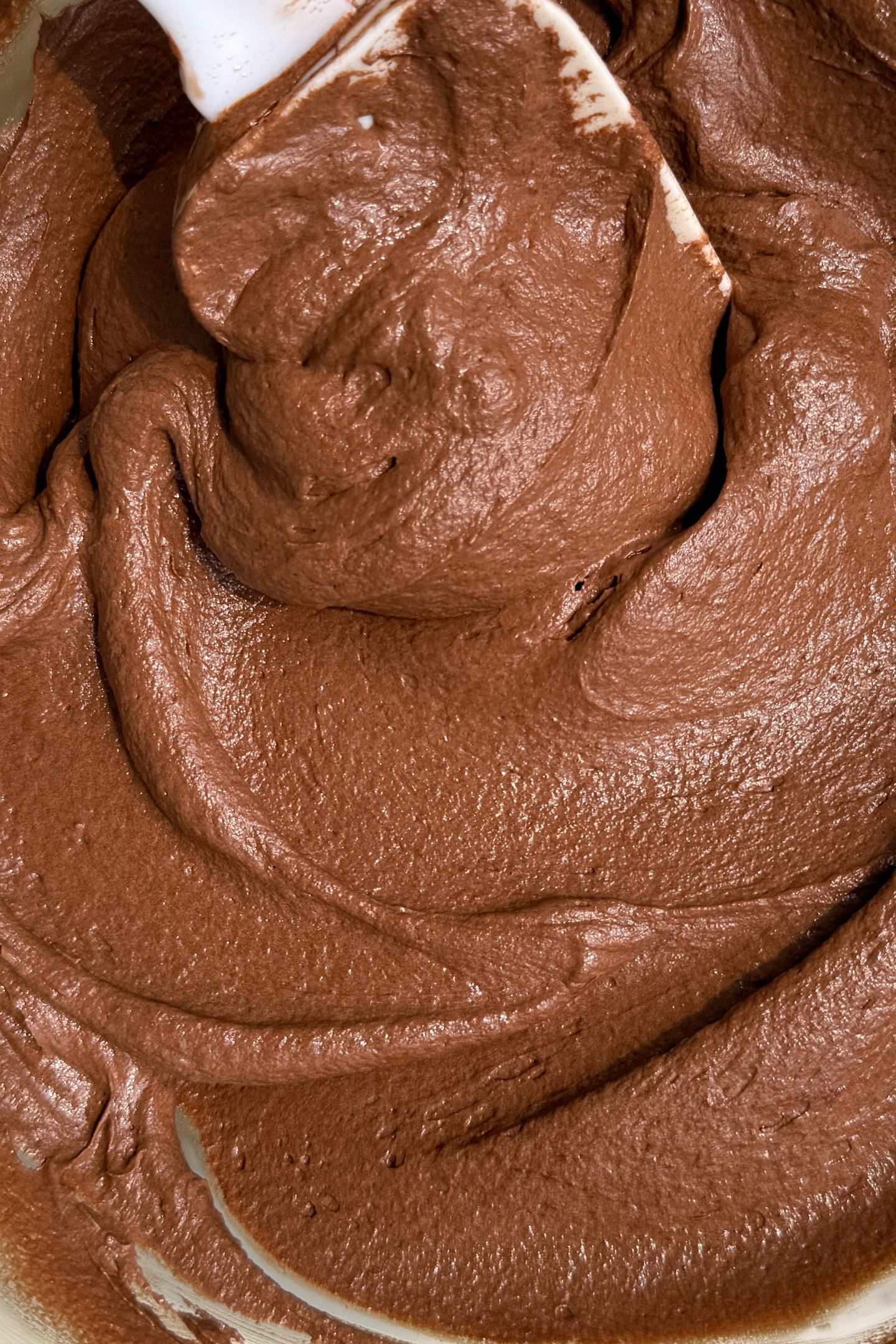 Chocolate buttercream frosting in a bowl.