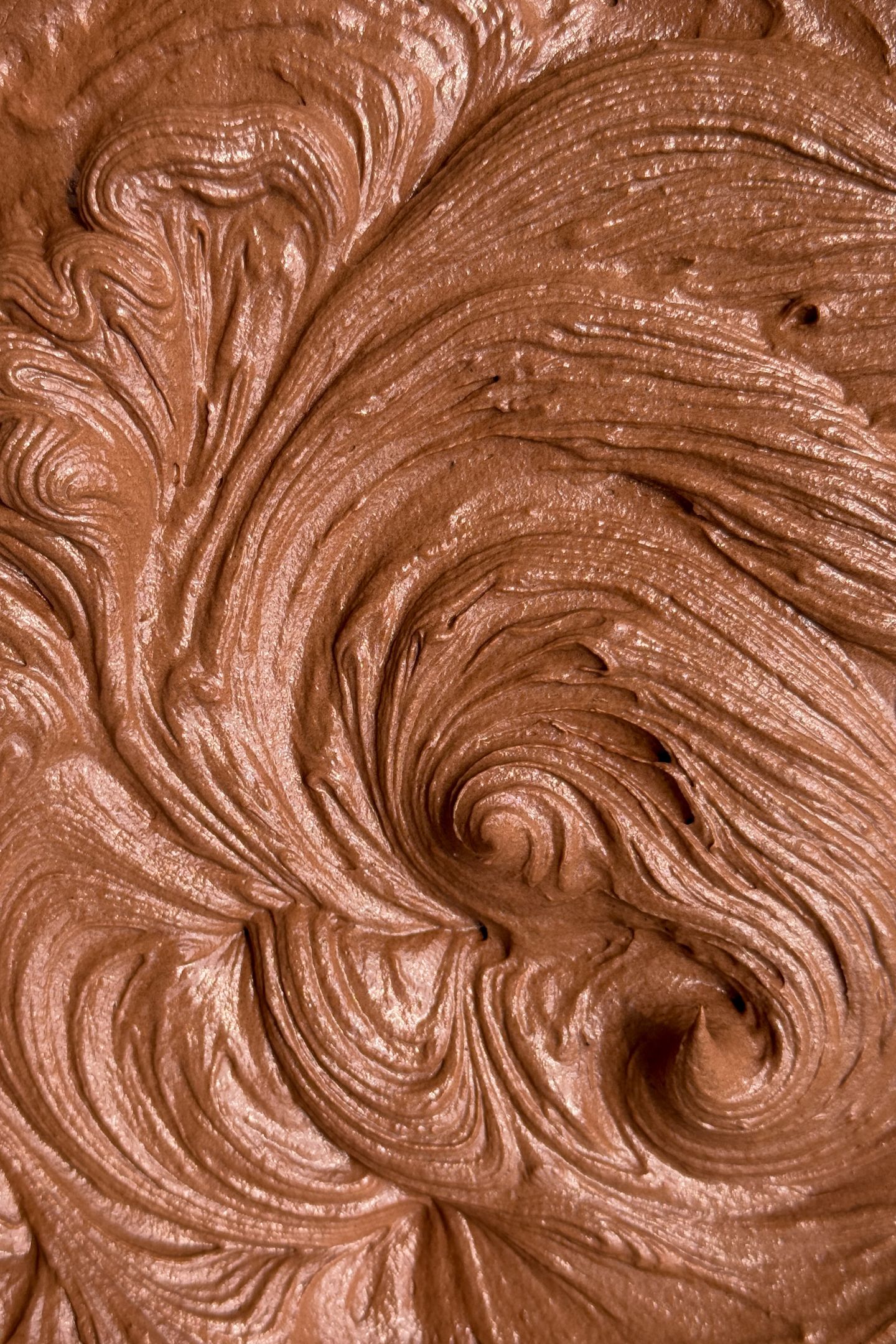 Chocolate buttercream frosting in a bowl.