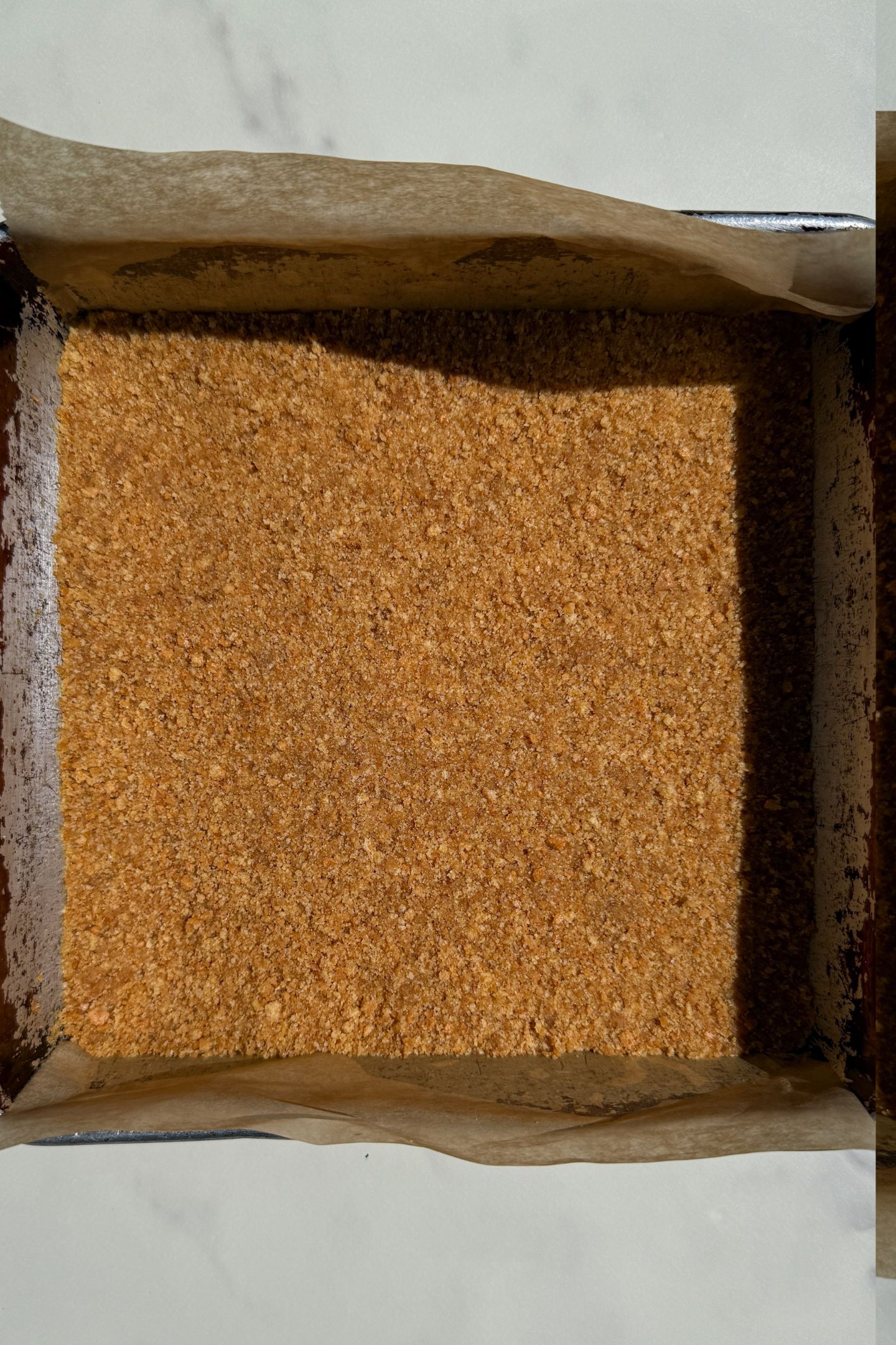 Graham cracker crust added to the pan.