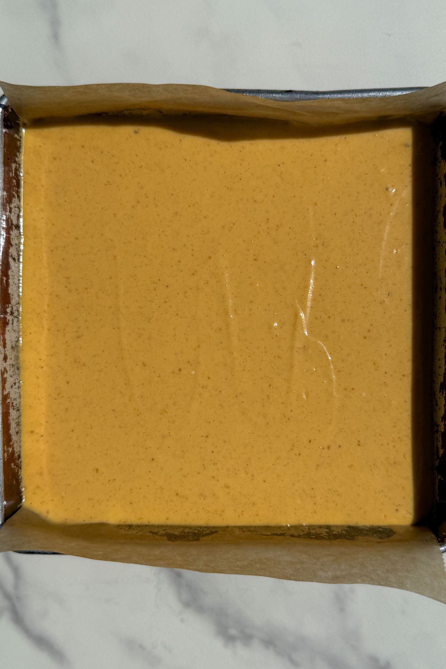 Cheesecake batter added on top of the graham cracker crust.