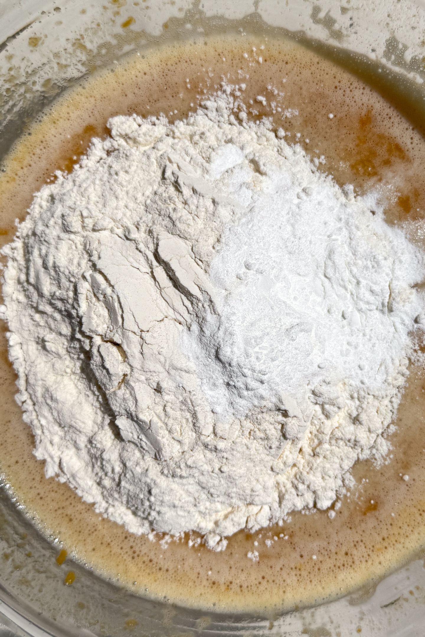 Adding flour to the wet ingredients. 