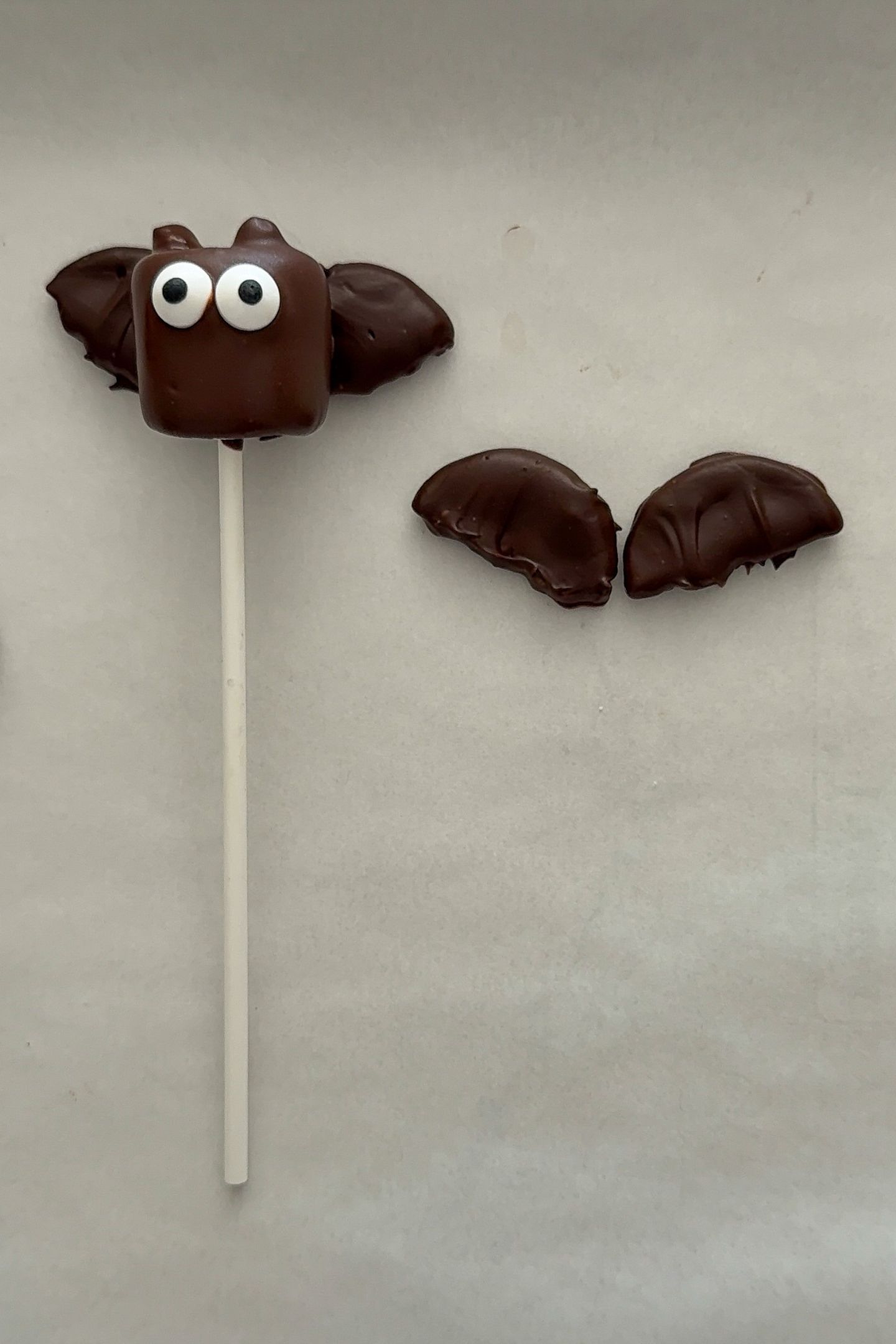 Assembling the bat marshmallow pops.