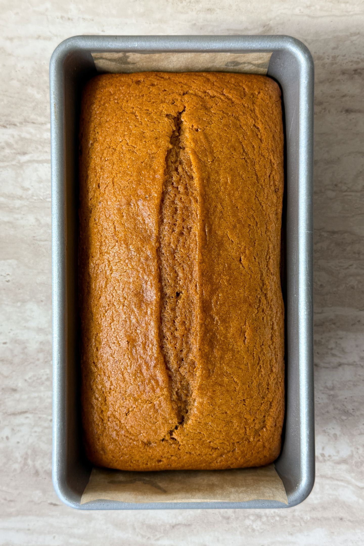 Baked pumpkin bread in the loaf pan.