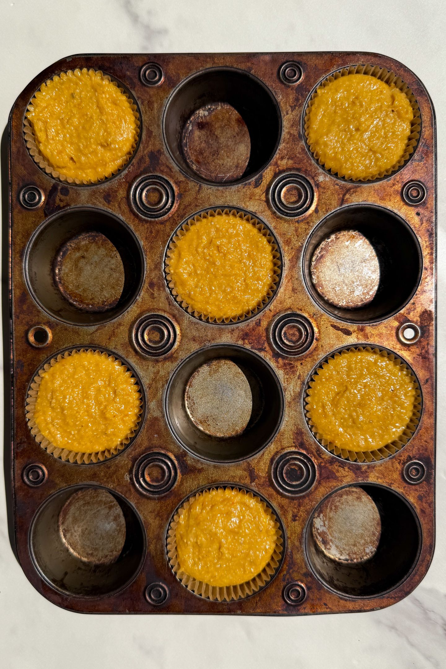 Corn muffin batter in the muffin liners.