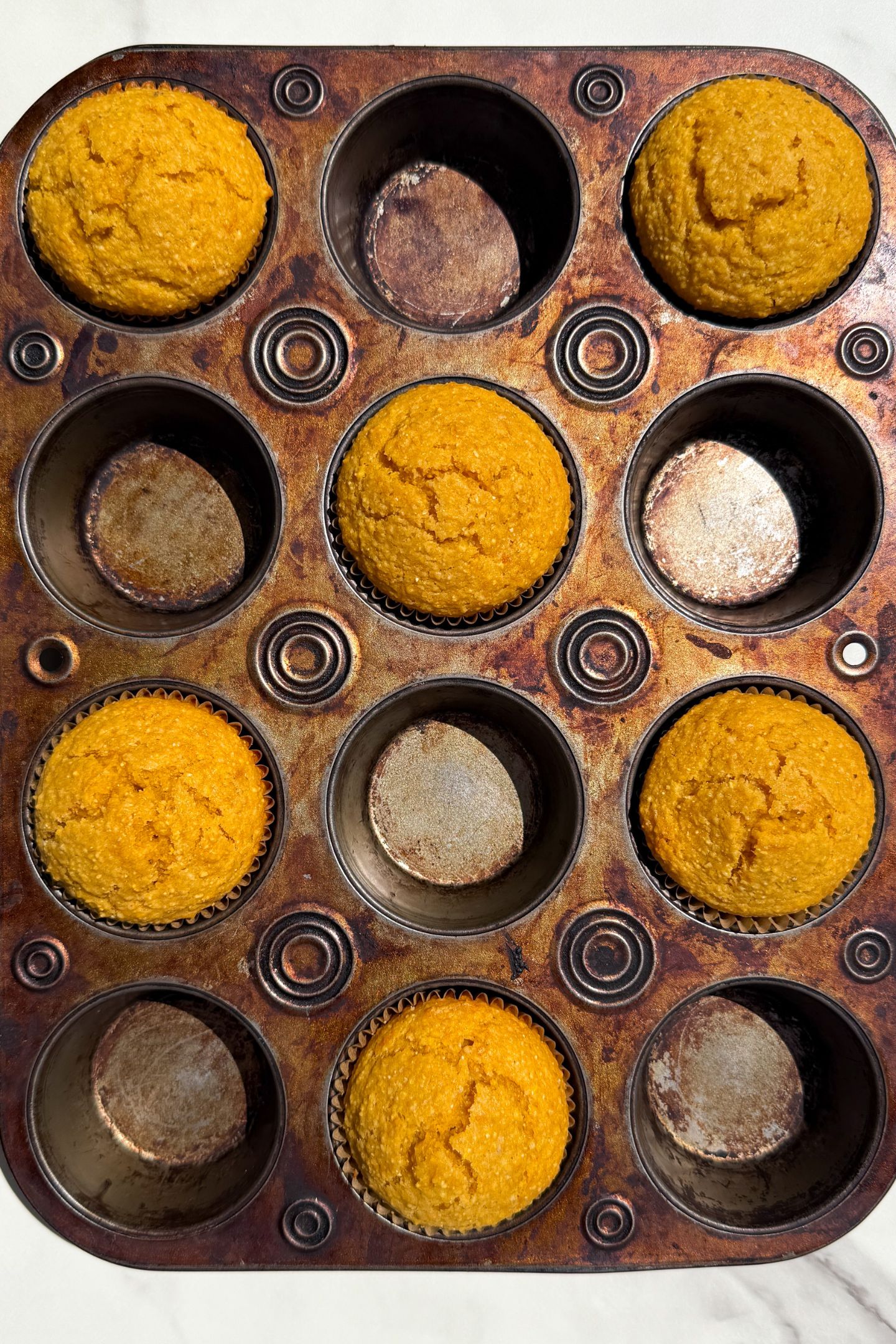 Baked sweet potato corn muffins in the muffin tin.